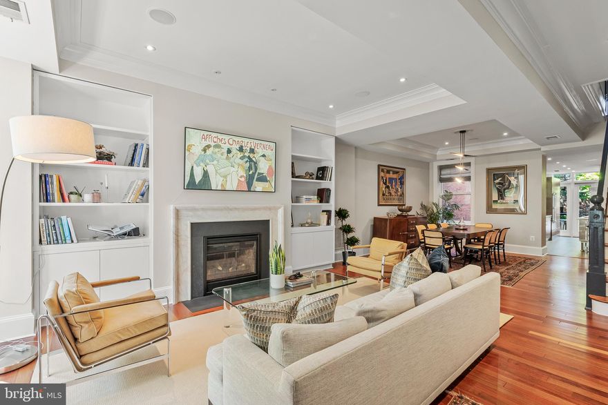 Historic and modern blend together in perfect harmony within this unique Logan Circle rowhome just steps from the 14th Street Corridor!  Its main level features a spacious, open concept living and dining room with a half bath for guests, decorative tray ceilings, and beautiful fireplace.  The kitchen has exposed brick, European cabinets, plentiful storage and a long, stainless countertop for more intimate, eat-in experiences.  A private deck off the kitchen overlooks a lovely garden with mature plantings, providing a perfect landing spot for outdoor entertaining.  The upper level includes a generous bedroom suite with lots of windows for natural light, a large den, a second bedroom and bath.  The second upper level holds an expansive primary suite and a stunning full bath with frosted glass pocket doors, a double sink vanity, and a large double shower.  A space with a wine refrigerator and storage that can be used as a sitting area, or an exercise nook, opens directly onto a private balcony as an alternative, intimate place to enjoy dinner, or your morning coffee.  The residence holds multiple rental or Airbnb opportunities as well.  There is a 1 bedroom, 1 bath Carriage House apartment above the 2-car garage with tandem parking and a 1 bedroom, 1 bath terrace level unit with a walkout to the rear garden.  With easy access to Logan Circle’s bustling 14th Street corridor, restaurants, shops and nearby U St, this residence commands a prime position that has it all!