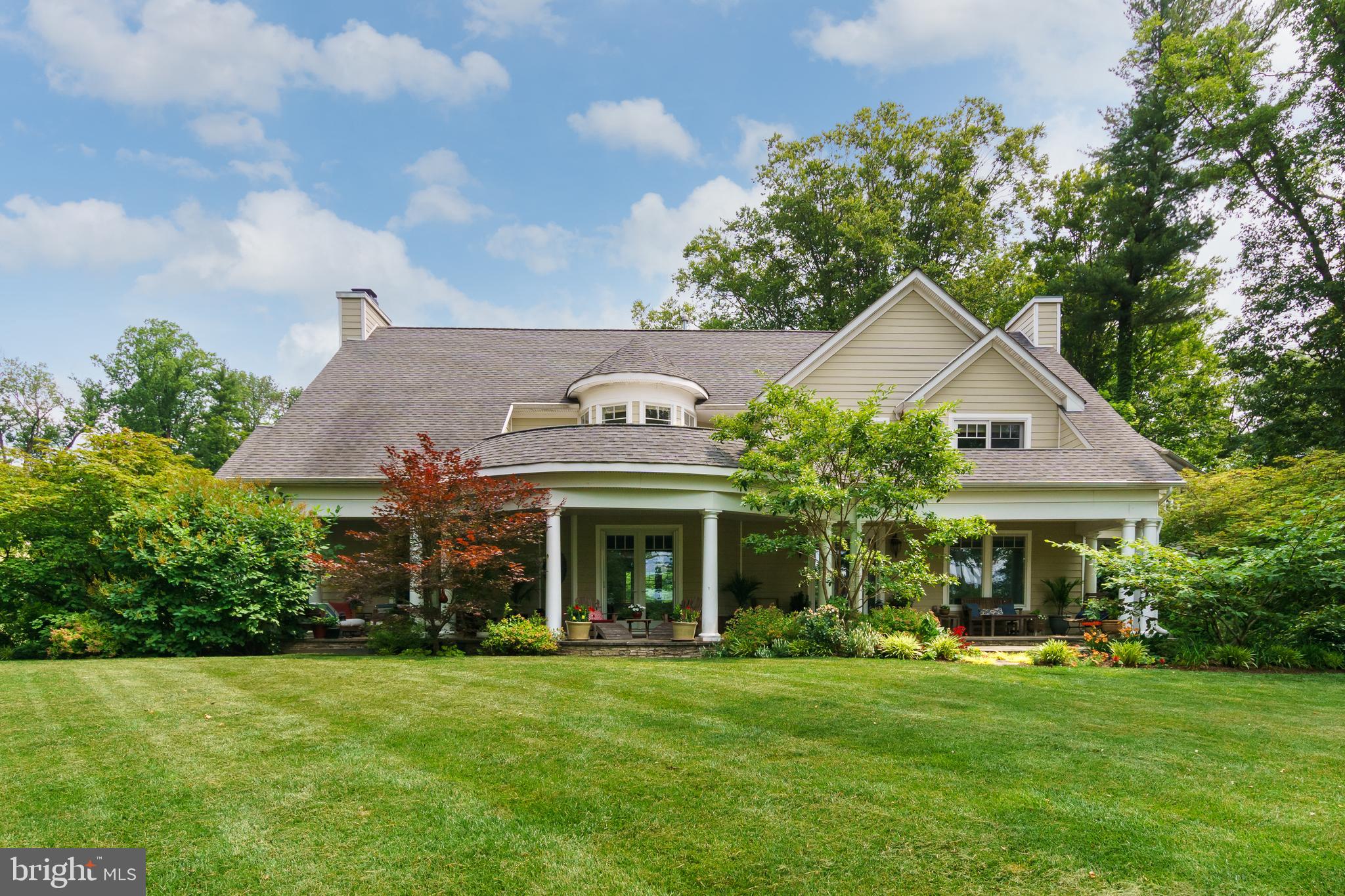 In a beloved Hun School Neighborhood, situated on a beautiful and lushly landscaped lot, this four-bedroom (with potential for a 5th), 5.5-bath home greets with inimitable character and an incredibly comfortable and versatile floor plan. The open-concept living and dining areas provide plenty of room for gatherings no matter the size, with an expansive kitchen at the heart. The architectural details found throughout add character and depth to each and every space. Rich crown moldings, soaring tray ceilings, a beautiful staircase with eye-catching newel posts and balusters, and atrium-style wavy glass pocket and French doors are just some of what you’ll find here. The kitchen features a suite of Dacor appliances, including double ovens, a cooktop, and a warming drawer. The center peninsula is what brings everyone together with seating for five, a large double sink, and a butcher block workstation. The oversized mudroom has its own door out near the three-car garage and the powder room. At the opposite end of the main level, there’s a guest bedroom and a full bath. Multiple doors open to the professionally landscaped and hardscaped backyard with a bluestone patio, a pond, and a waterfall plus there’s plenty of space for a pool. When not relaxing here, surrounded by carefully chosen plantings, the oversized front porch has zones for all sorts of entertainment, whether that be cocktails under the stars or relaxing with a good book on a lazy weekend. The basement offers vast recreation space, with a media area, family room, kitchen with a dishwasher, fridge, and microwave, and even a gym and fullbath. The second-floor houses comfortable bedroom spaces with abundant closet storage and ensuite bathrooms for each bedroom. The 4th bedroom was initially intended to be two, offering a junior suite-type setup that, with some reconfiguring, could be converted to add a fifth bedroom. The main suite shows off pampering amenities, from an oversized rain shower with wall jets in the bathroom to designer dressing closets in the bedroom. Don’t miss this rare opportunity in one of Princeton’s most sought-after neighborhoods!