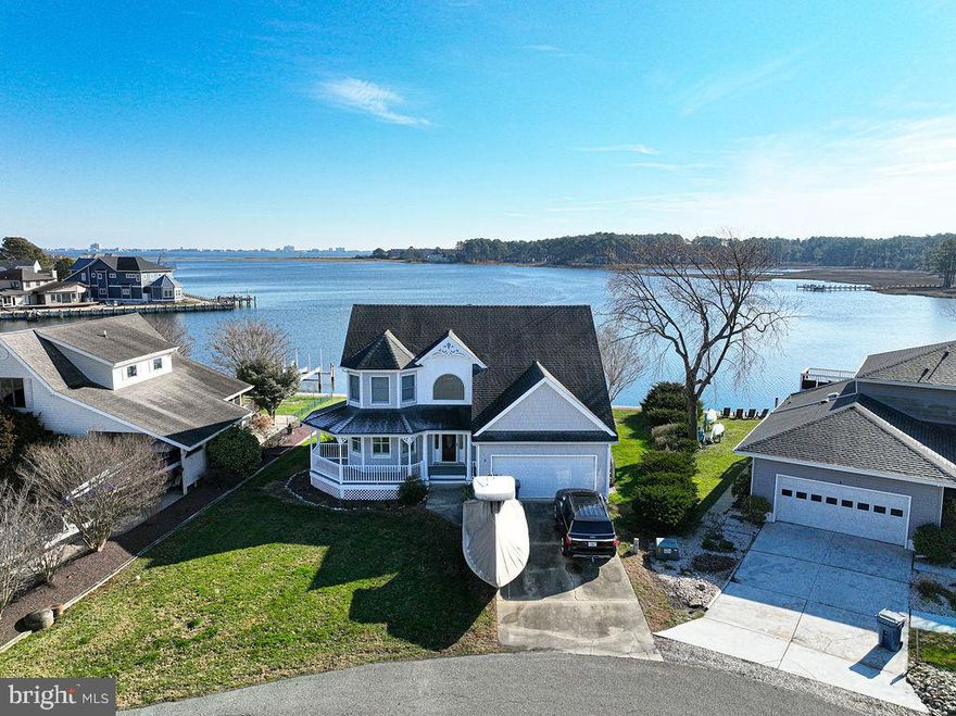 Panoramic views of the Ocean City Skyline, Isle of Wight Bay & Manklin Creek! Located at the end of a quiet cul-de-sac street in the award-winning, amenity filled community of Ocean Pines.  Includes a private deep water pier with Boat Lift and guest slip.  Five Bedrooms provide plenty of room for family and friends.  Two Story ceilings, Brazilian Cherry floors,  and an impressive floor to ceiling stone fireplace adorn the Great Room, along with a window wall to absorb the breathtaking views.  Cooking will be a delight with Stainless Steel appliances, granite countertops, Plantation Shutters and a large breakfast bar.  The first floor primary suite features a deep whirlpool tub, large vanity and separate tiled shower.  One of the 2nd Level Bedrooms leads to an impressive covered balcony with glass panel railings.  Now's your chance to purchase a waterfront home in a great neighborhood!!