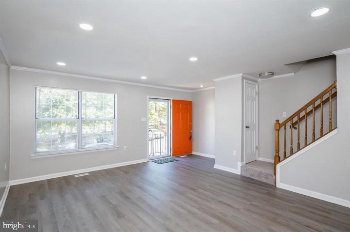 Welcome home to this beautifully renovated townhome in the desirable Gilmer Woods community. Featuring 3 spacious bedrooms, 2 full baths upstairs, and a finished basement with a half bath, this home offers over 1,500 square feet of comfortable living space. Recent upgrades include a new roof (2021), fresh paint throughout, brand new vinyl flooring on the main level and in the upstairs bathrooms, and new carpet upstairs. The kitchen boasts granite countertops, a new dishwasher, freshly painted cabinets, and a new sliding glass door. The living room is enhanced with crown molding and recessed lighting, while the upstairs bathrooms have been fully updated with new flooring, vanities, toilets, tubs, lighting, and mirrors. The finished lower level adds flexible space for entertaining or relaxing. Enjoy assigned parking, a rear deck, and the convenience of lawn care, snow removal, and trash service included in the monthly HOA fee. Located near major roadways, shopping, and dining, this home blends style, comfort, and accessibility. The property is being sold strictly as-is; the seller will make no repairs.