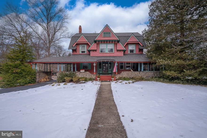 Rarely available in Historic South Wayne: a beautifully expanded Colonial set on nearly an acre, offering almost 4,500 square feet of flexible living space, meticulous updates, and timeless Main Line character at 421 Midland Avenue.

Thoughtfully expanded by Cottage Industries with full blueprints and permits, this addition increased valuable square footage while preserving the home's original charm. The expansion includes a first-floor en suite bedroom with full bath, powder room, and mudroom designed to enhance both flow and everyday livability.

The first floor welcomes you with a large covered front porch and an adjoining screened-in porch, ideal for both quiet mornings and relaxed entertaining. Additional porches extend from both the first-floor en suite bedroom and the mudroom just off the kitchen, creating multiple opportunities for indoor-outdoor living on this generous lot. Inside, hardwood floors run throughout, complemented by rich oak woodwork and a central oak staircase anchoring the main level. The foyer leads to a formal dining room framed by solid oak pocket doors, setting an elegant tone for gatherings. The home offers a series of generously sized, light-filled rooms with classic details, including a living room with fireplace and several bright wood-framed windows, and a handsome library with gas fireplace and access to an enclosed patio. The kitchen includes a pantry closet and opens seamlessly to the family room, which features a distinctive wood-planked ceiling and warm, inviting atmosphere. The first-floor en suite bedroom is enhanced by French doors and a wood-burning fireplace, creating a comfortable and private retreat.

The second floor offers four well-proportioned bedrooms and two full bathrooms, including a primary bathroom with both soaking tub and separate shower. The third floor adds further flexibility with two additional bedrooms, a full bath, cedar closet, and dedicated storage room ideal for guests, home offices, or creative use.

The expansive basement offers exceptional ceiling height and recent waterproofing, providing abundant space for storage, workshop use, or future customization to suit your needs. Recent major system upgrades offer peace of mind and include newer roof, siding, gutters, repointing, plumbing, electrical, heating, and newer installed central air conditioning. The home is equipped with two efficient high-velocity heating systems and two-zone central air. All bathrooms have been fully renovated within the past three years, and the exterior has been completely refreshed.

Additional features include a built-in carport, a three-bay garage with high ceilings and second-floor electric service suitable for conversion to a studio or workshop, three fireplaces (two gas and one wood-burning), and a 220-volt setup suitable for EV charging.

Ideally located close to the center of Wayne, the train station, walkable shopping and dining, and situated within the highly rated Radnor Township School District, this home offers a rare combination of scale, craftsmanship, and enduring Main Line appeal.