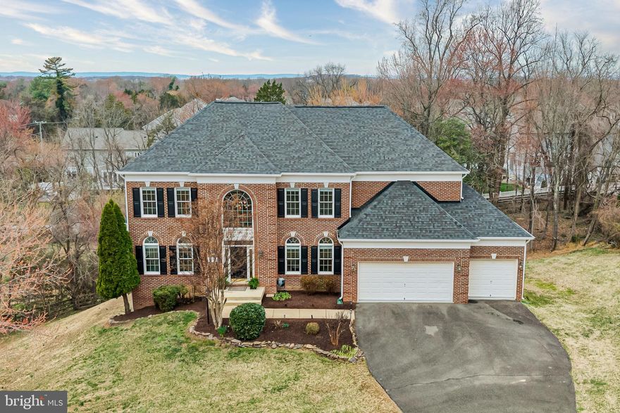 Set on a rare 0.86-acre lot in Herndon, tucked quietly on a cul-de-sac, this stately home offers something increasingly hard to find: space, privacy, and over 5,300 square feet to truly spread out—inside and out. 

The expansive yard is a standout feature. With nearly an acre of land, there’s room to run, play, entertain, garden, or simply enjoy the peace and quiet—an incredible advantage for anyone with a love of outdoor living.  

Inside, a dramatic two-story foyer welcomes you with hardwood floors, crown molding, and a stunning palladium window that fills the space with natural light. Dual staircases create an easy flow throughout the home, while spacious living and dining rooms offer plenty of flexibility for hosting gatherings big or small. 

At the heart of the home, the kitchen has been thoughtfully refreshed with a full suite of stainless-steel appliances (December 2023), including a Bosch 800 Series dishwasher and KitchenAid double wall ovens. Granite countertops, under-cabinet lighting, a 5-burner LG gas cooktop, and an island with breakfast bar make it equally suited for everyday living and entertaining. The sunny breakfast room—wrapped in casement windows and right off the kitchen—opens directly to the deck, where sunset views become part of your nightly routine. 

The adjacent family room, centered around a gas fireplace with granite surround, is warm and inviting. A main-level den offers valuable flexibility for a home office, study space, or library. 

Upstairs, the primary suite serves as a peaceful retreat with a tray ceiling, private gas fireplace, and tranquil views. The spa-inspired bath features a soaking tub, frameless glass shower with bench, dual vanities, built-in shelving, and a walk-in closet with custom organizers and laundry chute. Three additional bedrooms—one with an en-suite bath and two with a Jack-n-Jill bath—provide comfortable accommodations for family and guests. 

The walk-out lower level adds meaningful versatility, offering a large recreation room filled with tons of natural light and direct access to the patio and backyard. Whether you envision a gym, media room, play space, or future guest suite (with plumbing already in place for a bath), this level gives you options that evolve with your needs. 

Outdoors, the nearly one-acre setting truly shines. A wooden deck, screened-in gazebo with ceiling fan, brick and flagstone patios, and a covered area beneath the deck create multiple spaces to gather throughout the seasons. And when the day winds down, the wide-open horizon delivers remarkable sunset views you won’t soon forget. 

Additional highlights include a 3-car garage with MyQ smart opener, Ecobee smart thermostats, dual-zone HVAC with recent updates, and a roof replaced in 2021. 

Located just minutes from North Point Village Center (6 minutes), Reston Town Center (12 minutes), major commuter routes (Hwy 7, FX County Pkwy, 276 Toll road, Georgetown Pike), Tysons (17 minutes) and Dulles International Airport (17, minutes), this home offers the rare combination of privacy, property, and proximity. 

A spacious cul-de-sac retreat on nearly an acre—right in the heart of Herndon.