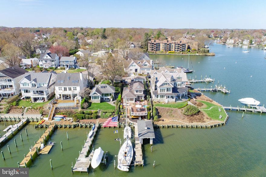 If you want the best water view on Spa Creek, you found it here!  205 Lockwood Court is the preeminent waterfront location with sunrise to sunset, twilight to the wee-small-hours views of the beautiful Historic Annapolis skyline and Spa Creek.  Grill on the large brick patio. Relax on the expansive 20” x 32” deck any day or night and watch the ever-changing water activity - kayakers, paddle boarders, water taxis, .  Enjoy VIP seating, for Lights Parade, 4th of July and New Year's Eve fireworks.  Dock your boats on the 65’ pier.  And the boat house!   35' x 13' with electric  lift for up to 22' x 7.7" boat,  an automatic "garage door", a workshop area and safe storage.   This classic boat house is one of just a few functional boat houses in Annapolis.  The water side of the house is all windows and French Doors allowing water views from the Living Room, Dining Area, Kitchen and second-level Guest Room.  The efficient galley kitchen houses high-end appliances Miele Coffee Maker, Sub-Zero, 24-bottle wine fridge, 48' Sub-Zero fridge, Wolf Convection Microwave, Wall Oven and Range, granite countertops, unique track lighting and skylight.   Gleaming hardwood floors in the Living Room, Dining Area and Kitchen and unique beadboard ceilings original to the house.  The Primary Bedroom and Bedroom #2 are on the main level, both with vaulted ceilings, ceiling fans and skylights. Bedroom  with an expansive view of Spa Creek is on the second level.  There is a basement for your storage needs.  Parking for 2/3 cars.  Walk to Historic Annapolis and numerous restaurants in Eastport, from coffee shops to fine dining.