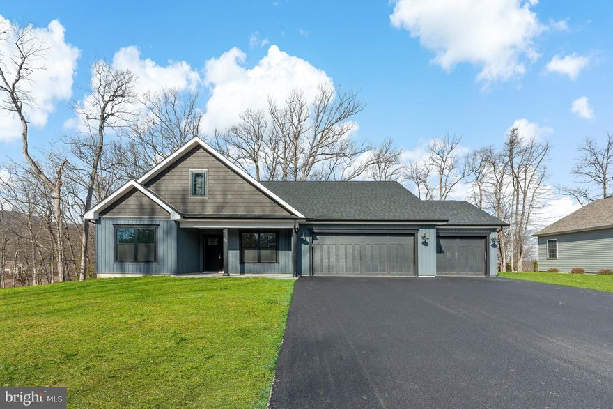 TO BE BUILT!  Pictures are of this same floorplan on a different lot with different color choices.  Ready March 2025 - You can still pick out your cabinets, flooring, and countertop if you hurry! Don't miss your chance to build your own home with this 'Jayson' floorplan from Panhandle Homes of Berkeley County's Signature Series line.  This home features almost 1,700 square feet of living space PLUS a 3 car garage!   The split bedroom plan offers 3 bedrooms and 2 bathrooms with a large and open kitchen, dining and living area.   The Owners Suite has a large Ceramic Tile walk in shower and a dual bowl vanity. A laundry/mudroom, media closet and pantry are conveniently located between the garage, owners suite and kitchen.   Wind down in the Great Room with its cathedral ceilings and electric fireplace.  Located on top of the mountain, this home has a 17.5' x 12' covered rear porch which is great for enjoying the wonderful nature and wildlife found in The Woods Resort.  This lot is eligible for a Class A Membership, which offers incredible amenities such as indoor/outdoor pools, spa, sauna, fitness center, golf courses, tennis and more!
