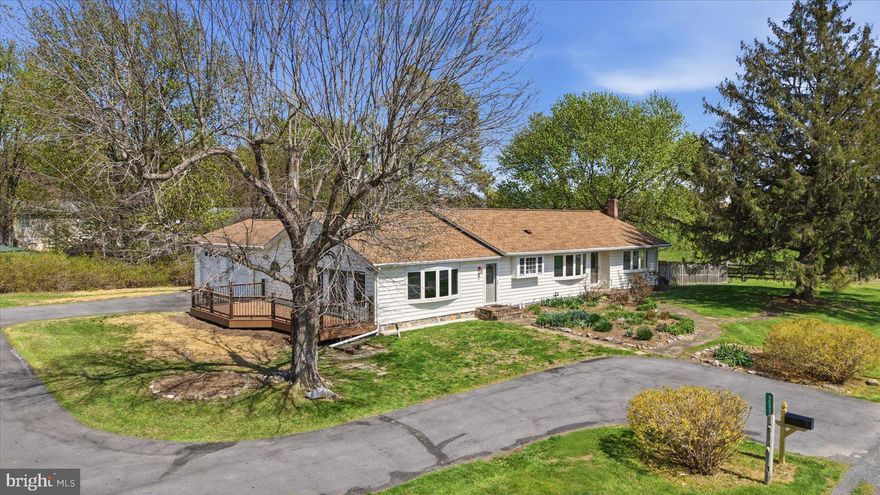 Set on 1.06 acres just outside downtown Charles Town and Ranson, this 4-bedroom, 3-bath ranch-style home offers one-level living with a practical, low-overhead setup that is increasingly hard to find. A paid-off solar array (with $6/mo electric bill), 2-year-old high-efficiency HVAC system, private well, whole-house water treatment with reverse osmosis drinking water, and space for gardening and chickens support a more self-directed lifestyle without sacrificing convenience. The main level includes hardwood and ceramic tile flooring, a bright living room with bow window, formal dining room, kitchen with garden window, spacious primary suite with walk-in closet, soaking tub, separate shower, and private Trex deck, plus a second bedroom, or "princess suite," with its own bath. Two additional bedrooms share a third full bath. Outdoor features include a circular drive, attached 2-car garage with dog wash station, fenced pet yard, patio and garden terrace with retractable awning, and storage shed with potting area. The finished basement adds valuable overflow space with tile flooring, a free-standing wood stove, custom wet bar, and a large storage and laundry room with built-in cabinets. All of this is just minutes from the shops, dining, and everyday conveniences of Charles Town and Ranson, offering an increasingly rare balance of accessibility and room to live more intentionally.