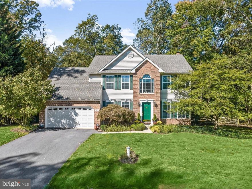 Nestled on a serene 1.93-acre lot backing to lush trees, 878 Backbone Court offers the perfect blend of elegance and privacy. This stunning colonial is designed for both relaxation and entertaining, featuring a tiered deck, a custom slate patio, a tranquil water feature, and a fenced backyard—ideal for outdoor gatherings. Step inside to a grand two-story foyer flanked by formal living and dining rooms adorned with classic moldings. The beautifully renovated eat-in kitchen boasts Quartz countertops, decorative backsplash, center island with a breakfast bar, soft-close cabinetry, display cabinetry, a pantry, and a sunlit breakfast room with direct access to the deck and backyard. Adjacent to the kitchen, the inviting family room is anchored by a cozy stacked stone fireplace, creating a warm and welcoming atmosphere. A powder room and a mud/laundry room complete the main level. Upstairs, the luxurious primary suite offers a private retreat with a spacious sitting room, a walk-in closet, and a renovated en-suite bath featuring dual vanities and a glass-enclosed shower. Three additional bedrooms and a full bath complete the upper level. The lower level expands the living space with a game room featuring built-ins and access to the slate patio, a media room, a powder room, and ample storage. Recent updates include a new hot water heater (2024), gas furnace, central air, well head replacement (2021), and more!