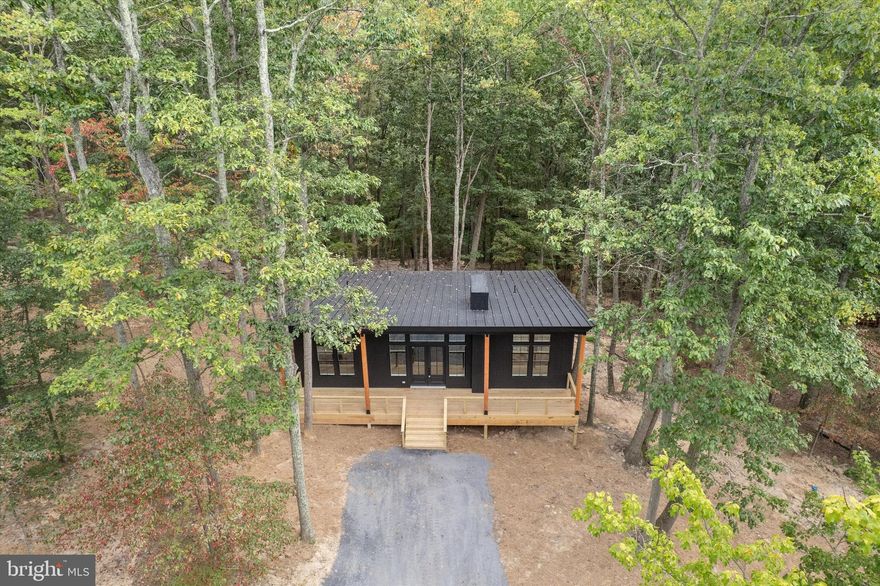 Welcome home to this custom built, one level home featuring 1,378 finished square feet, 3 bedrooms, and 2 bathrooms, all designed with an open concept floor plan. The durable Hardie shaker style exterior sets the tone for quality craftsmanship throughout. 

Inside, vaulted ceilings and rich hardwood flooring create an inviting atmosphere, while the living room offers a cozy electric fireplace and abundant natural light. The gourmet kitchen with quartz countertops is a true highlight, featuring upgraded stainless steel appliances, an oversized island with breakfast bar seating, a sage green tile backsplash, and designer light fixtures. The primary bedroom suite includes a spa like bath with dual sinks, quartz counters, and a walk in shower with custom tile accents. Two additional bedrooms share a full hall bath with tub/shower combo, sage green tile, and quartz finishes. 

Situated on a 1 acre wooded lot, this Harpers Ferry home for sale offers privacy, tranquility, and plenty of space to enjoy the outdoors. As part of a private community, residents also enjoy exclusive access to the Shenandoah River, perfect for fishing, kayaking, or simply relaxing by the water. There is also a wet-weather creek in the back of the property.  Located in historic Harpers Ferry, this property provides the serenity of a cabin in the woods while still being close to hiking trails, national parks, wineries, and commuter routes into Northern Virginia and the DC metro area. 

If you are searching for a modern cabin in Harpers Ferry WV, a new construction home near the Shenandoah River, or a West Virginia retreat for sale, 82 Christ Church Road offers it all — modern amenities, thoughtful design, and the beauty of nature at your doorstep.