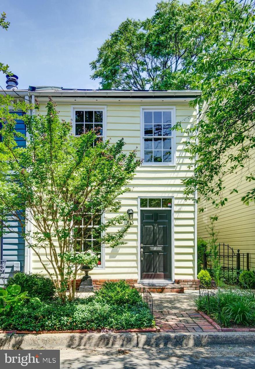Built in 1900, this semi-detached 3/4 BR 2.5 BA townhouse is awash in sunlight.  Gleaming reclaimed floors welcome you into a large living room and dining area all the while enjoying natural light from multiple east windows.  An open concept floor plan beckons you to the updated kitchen with exposed brick walls, stainless appliances and a handsome island with great storage and beyond to the marvelous family room with French doors to the private patio.  Convenient powder room on the first floor.  This continuous flow is perfect for everyday living plus entertaining.  Upstairs is a real treat....there are 3 bedrooms on the second floor and 2 full renovated baths.  The guest room features a vaulted ceiling and large closet.  The owner's master bedroom suite is a haven from a busy day.  On the private side of the house, this master bedroom offers a wall of closets and many windows.  The same beautiful floors are found on this second level.  A 3rd level in the house is a great room for an office, a child's game room or extra sleeping space for unexpected guests....aloft a Harry Potter kind of space with small attic window.  Total of 1958 sq ft of wonderful private living space will please the discerning buyer as this property is convenient to the Metro, to the airport and to all Old Town shops and restaurants  Plus, there is a storage shed large enough for your bike!  The garden is professionally planted with holly, miniature boxwoods, nandina, and azaleas.  Take a virtual tour: https://tours.linenandlens.com/1619612