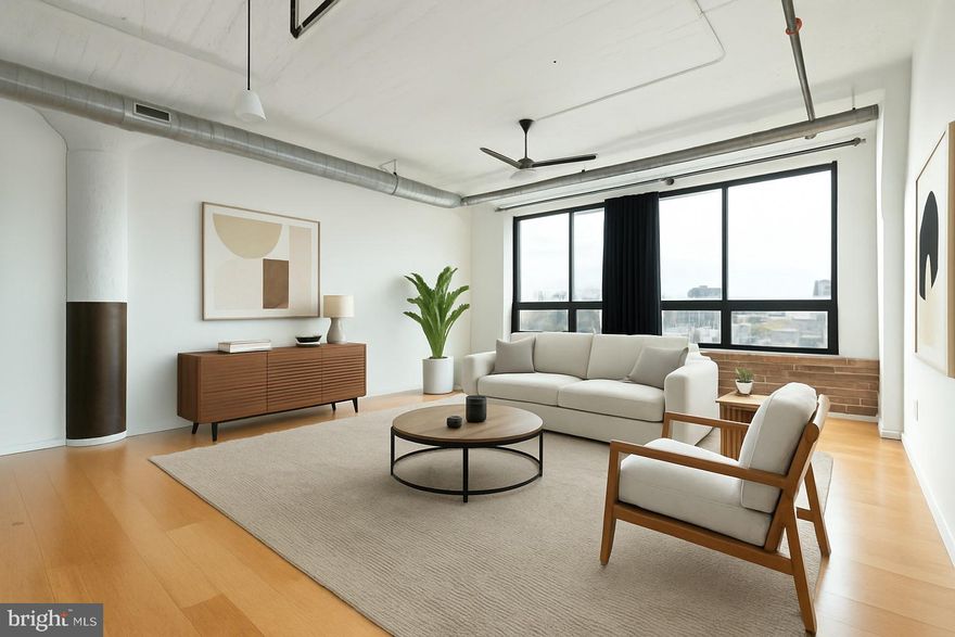 Experience authentic loft living at Memphis Flats, one of Fishtown’s most distinctive condominium conversions. Originally a turn-of-the-century industrial building, this thoughtfully restored landmark now houses sleek contemporary residences that celebrate Philadelphia’s creative heritage. Residence 313 offers approximately 966 square feet of open living space with soaring 11-foot ceilings, exposed brick walls, and concrete columns that define the home’s character. Expansive south-facing, wall-to-wall windows fill the interior with natural light throughout the day while framing tree-lined neighborhood views.The open-concept layout connects the kitchen, dining, and living areas for effortless entertaining. The kitchen features stainless-steel appliances, ample cabinetry, and modern countertops, blending functionality with minimalist design. Additional highlights include hardwood bamboo flooring, recessed lighting, and a spacious bedroom suite with generous closet space. A large full bath and in-unit washer and dryer complete the home’s smart, efficient layout. This condo includes a deeded off-street PARKING SPACE (#60) and a private storage unit, offering rare convenience in Fishtown. Residents of Memphis Flats enjoy secure elevator access, a fitness center, and a resident lounge, all maintained with low monthly condo fees. The building combines historic architecture with modern infrastructure, including central air conditioning, energy-efficient windows, and professional management.Located in the heart of Fishtown, one of Philadelphia’s most vibrant neighborhoods, Memphis Flats places you steps from La Colombe Coffee, Suraya, Wm. Multer & Co., Front Street Café, and the Girard Station EL stop for quick access to Center City. Enjoy proximity to Penn Treaty Park (0.6 mi), River Trails, and convenient routes to I-95 and the Ben Franklin Bridge.Whether as a full-time residence or a low-maintenance pied-à-terre, Unit 313 offers the perfect combination of industrial charm, modern comfort, and urban accessibility in one of Philadelphia’s most desirable neighborhoods.