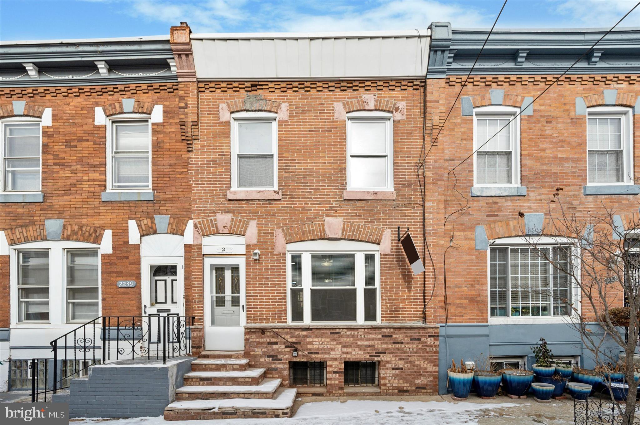 Welcome to this stunning brick-front residence nestled in the vibrant heart of Point Breeze. This captivating home boasts a charming exterior that sets the tone for what lies within. Step inside to discover two generously sized bedrooms bathed in natural light, complemented by a beautifully designed three-piece bathroom. The large living room exudes warmth and comfort, featuring new ceiling fans and an elegant gray palette paired with a striking brick-faced fireplace—perfect for cozy nights in. The kitchen is a chef's dream, showcasing gorgeous white cabinetry and sleek stainless steel appliances that blend style with functionality. The bedrooms offer a serene retreat, adorned with plush carpeting that invites you to sink in and unwind. The spacious bathroom is a true delight, featuring a stylish vanity that enhances the overall elegance of the space. This property is not just a place to live; it's a place you'll be proud to call home. Come and experience the allure of Point Breeze living!