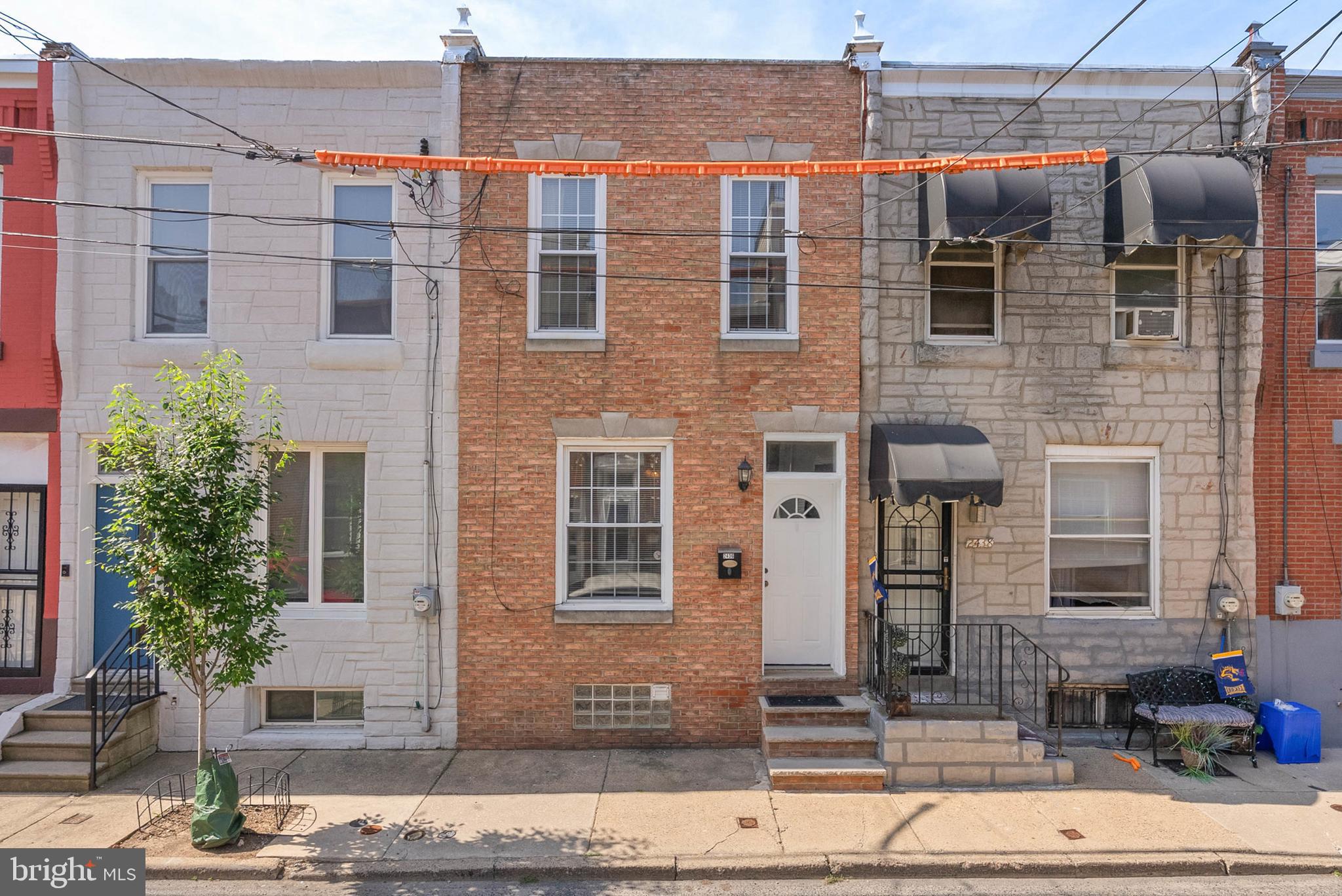 Tucked away on a low-traffic block in Philladelphia's sought-after Graduate Hospital neighborhood, you'll find 2436 Montrose Street. This renovated 2-story home has 3 bedrooms, 2.5 bathrooms, a finished basement, and a private patio. A classic brick facade greets you out front. Inside, high ceilings and hardwood floors frame the open and airy main level. The living room boasts a bright, oversized window, a ceiling fan, and a fireplace mantel. A separate dining area sits by a convenient powder room. At the rear is a large, sunlit kitchen fitted with custom wood cabinetry, a full suite of appliances, granite counters, a tile backsplash, and extra space for an island with seating. Sliding doors lead to a hidden patio, perfect for barbecues and al fresco dining. Down in the expansive finished basement, there's plenty of space for a gym, playroom, or home theater, along with the laundry and a full bathroom. Up on the second level, a bright bedroom with hardwood floors, a pair of tall windows, a ceiling fan, and lots of closet space is at the front. Two more bedrooms flank a full bathroom with vibrant green tile, down the hall. In addition to everything inside, 2436 Montrose St's fantastic location earns a Walk Score of 89! Popular restaurants, shops, and markets like Ants Pants Cafe, GIANT Heirloom, and an Amazon Hub fill the surrounding blocks. Nearby South St hosts community events, plus the extensive Schuylkill River Trail and Rittenhouse Square are both close. There's also easy access to public transit, Grays Ferry, the University of Penn, I-76, and Washington Ave. Schedule your tour today!