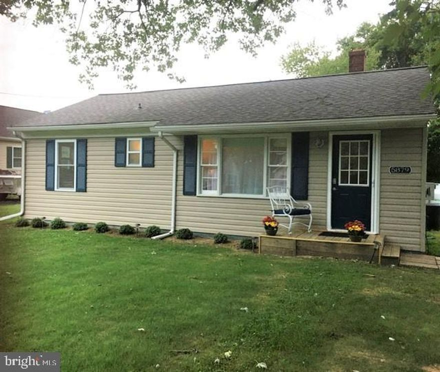 Looking for that sweet spot on the shore, close to the water and surrounded by the nicest people around? This cutie has been completely redone with you in mind. From the front door to the back patio, this house says "RELAX" .  As you enter the living room, you are greeted with calm, from the colors to the decor, you can feel yourself start to unwind.  No matter if you are making this your full time home or vacation spot, this home has all the amenities needed.  Redone from top to bottom and inside and out.  Two nice bedrooms, full hall bath, kitchen with table space, laundry room and half bath too. Appliances installed are like new, never used since installed.  Off the kitchen you have a nice large patio which is perfect to enjoy a crab feast or BBQ.   Hard to believe you are located in town, the large yard has plenty of room to store a boat, water toys, garden and play.  Walk to the town center where you will find shops, restaurants and festivals. This TURN KEY property would make a great VRBO, it can include all you and your guests need to start enjoying this laid back lifestyle. Remember to bring the boat but forget the flood insurance, it's not needed here.
