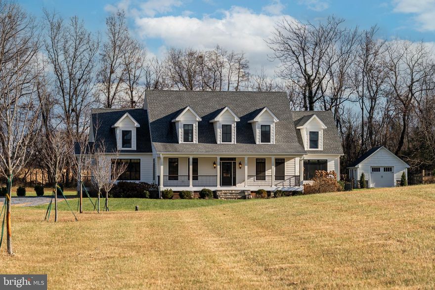 Discover an exceptional custom-built residence, completed in 2017 and showcasing refined modern farmhouse design throughout. Crafted with outstanding attention to detail, the home features premium finishes including Pella windows, low maintenance fiber cement siding, exposed barn beams, and custom trim. Outdoor living is elevated by a welcoming Trex front porch, full rear porch, and an expansive patio framed by handsome stone retaining walls. The main level offers a thoughtfully designed layout highlighted by a luxurious primary suite with an extra-deep tray ceiling, dual walk-in closets, and a spa-inspired bath featuring an open shower with herringbone tile inlay and dual vanities. At the heart of the home, the gourmet kitchen impresses with a soaring 23-foot cathedral ceiling, timber beams, leathered granite countertops, a 36" Bertazzoni gas range, and a charming breakfast/sitting area with coffee bar. The adjoining family room offers warmth and sophistication with a coffered ceiling and stone fireplace. The upper level includes two additional bedrooms, one full bath, while the fully finished lower level is ideal for an in-law suite. Enjoy serene country views backing to a large farm, a whole-house generator, and convenient access to downtown Purcellville amenities—an exceptional offering not to be missed.