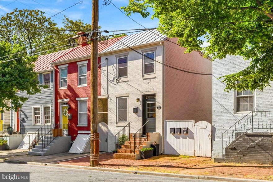 Welcome to the best of downtown Frederick living—just one block off Market Street. This Historic Preservation Award-winning 2-bedroom, 2.5-bath home has been thoughtfully renovated to showcase the perfect blend of historic character and modern design. From the moment you step inside, the home stands out. Exposed brick, wood beam ceilings, hardwood floors, and custom built-ins create a level of warmth and authenticity that’s hard to replicate. The living space is both inviting and functional, centered around a cozy gas fireplace and flowing seamlessly into a beautifully updated kitchen with white cabinetry, granite countertops, stainless steel appliances, and a timeless tile backsplash. Upstairs, you’ll find two spacious bedrooms, each paired with updated full baths, while a main-level half bath provides added convenience for guests. The outdoor space offers a private, fully fenced backyard with a brick patio and pergola—ideal for relaxing or entertaining—plus an upper-level porch for additional outdoor enjoyment. There is also potential for rented parking just beyond the rear privacy fence, a rare and valuable convenience in downtown Frederick. Located just steps from Market Street, you’re surrounded by Frederick’s best—award-winning restaurants, boutique shopping, breweries, art galleries, and Carroll Creek all within easy walking distance. With quick access to both Washington, D.C. and Baltimore, this is a rare opportunity to own a move-in ready home in one of Maryland’s most vibrant and walkable communities.