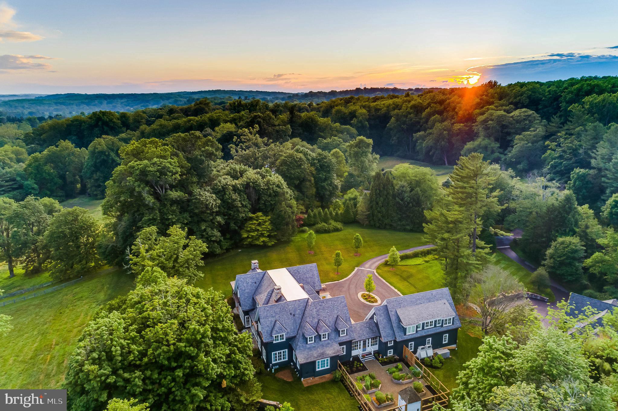 Live authentically. A visionary estate perched in prime Greenspring Valley with sweeping views of pastoral land in the distance. Enduring architecture reigns supreme. A settled northeastern aesthetic permeates every design decision. A palpable sense of arrival. Living sculpture. A vessel for life created with great purpose. Designed by Peter Ratcliffe, built by GYC, interior aesthetic realized by Purple Cherry and illuminated by Crampton Lighting Design. An inviting cooking and gathering space, light soaked and fresh. Flow to your indoor outdoor great room and savor fall evenings with friends in front of the fire with foilage ablaze... autumunal tones surround. Lively conversations and celebrations are enjoyed readily with your wine cellar strategically located in your dining realm. A dedicated lounge/movie room with kitchenette overlooking your indoor basketball/sports court complete with waterfountain. Deluxe golf simulation space. Intense functionality meets artistry. A floorplan so good it must be experienced to be appreciated. Luxe first floor primary suite. Addtional suite with private stair above the garage. Wonderful for guests or home office think tank. Unrivaled state of the art mudroom. A kitchen pantry that evokes the unforgettable organization of Dean and Deluca. Destination heated party barn with attached 1,000+ square feet two bedroom guest house and terrace. Staycation with ease. Just minutes from Greenspring Station and the 83. Cultivate your existence. The art of uniting human and home.