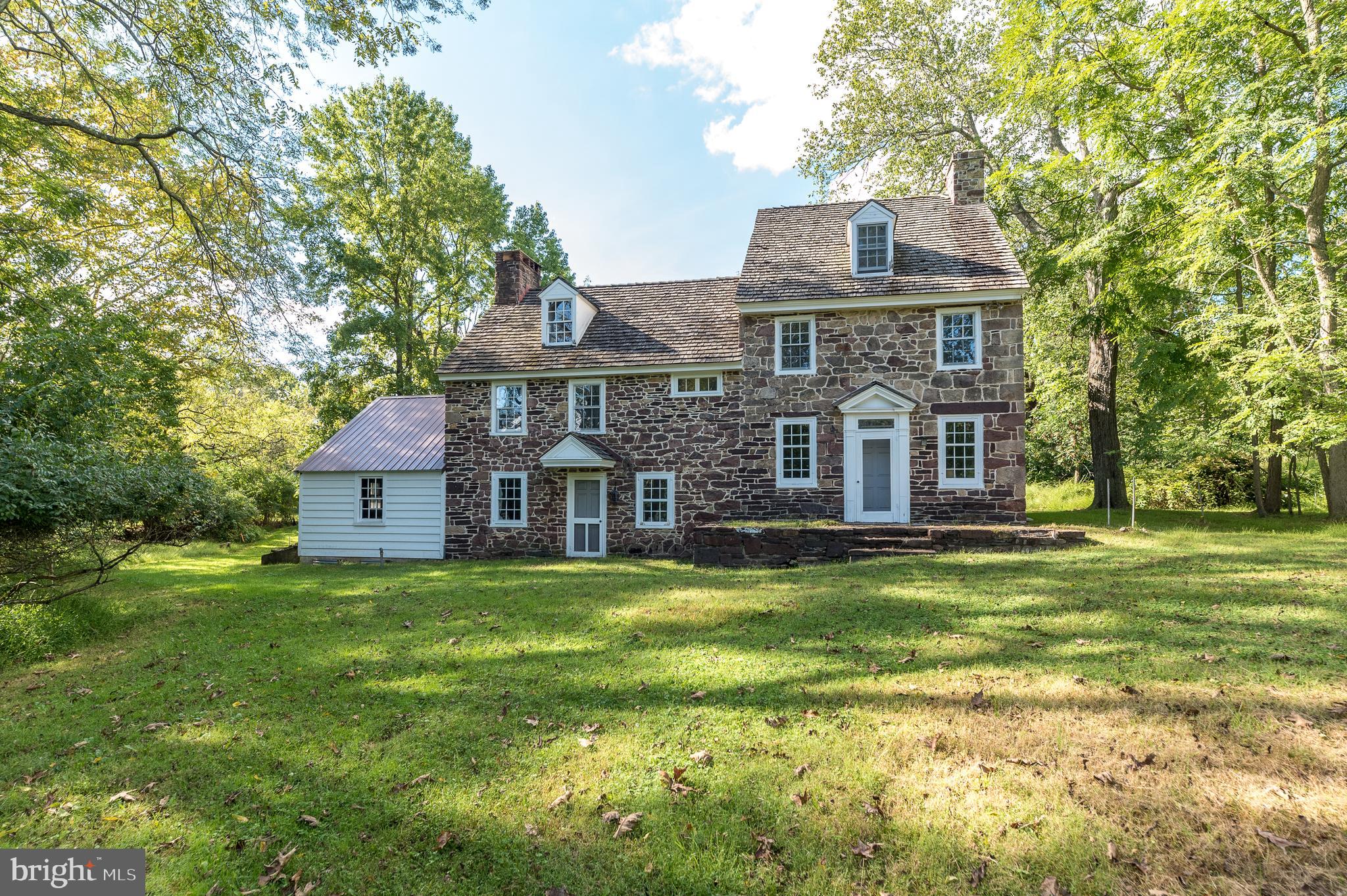 Welcome to the Owen Evans Homestead in prestigious Lower Gwynedd Township. Featuring two homes, the original stone residence circa 1710, a converted bank/ramp barn now an occupied residence with public sewer and public water, a newer horse barn, smoke house, garages, and outbuildings This amazing property is one of the four original Evans Homesteads in the area and is situated on 15.71 +-private bucolic acres containing 5 separate contiguous parcels. Although there are 5 deeded parcels, they are under one tax ID 39-00-04054-002 qualifying for preferential assessment under PA ACT-319. The beautifully pointed 5 bedrooms, 4 bath, stone farmhouse was renovated under the supervision
of renown architects Brumbaugh and Ruthrauff and still includes most of the original doors, cupboards, and beautifully crafted millwork and trim, this home, an architectural delight, set back off the main road
with privacy, spectacular picturesque views and ready for your restoration. The Spacious bank/ ramp barn converted into a residence in 1950 features 3 bedrooms, two bathrooms accented with the ambiance
of its many original barn details, an open floor plan with the stone fireplace creates a warm cozy place to sit by the fire or read your favorite book on a cold winter night. The lower grade level of the converted barn is a finished office space offers central air, public sewer and public water. The original farmhouse has a public water and on-site septic system. There is frontage on both Evans Road and Sumneytown Pike. There also are recorded easements and agreements from 1987 with the municipal authority providing for a possible subdivision scale sewer and storm water connections for your inquiry and investigation to be
confirmed. PLEASE DO NOT ENTER the property without an appointment. Conveniently located near restaurants, the train, shopping, major highways, and downtown Ambler. Sought after Wissahickon School District.