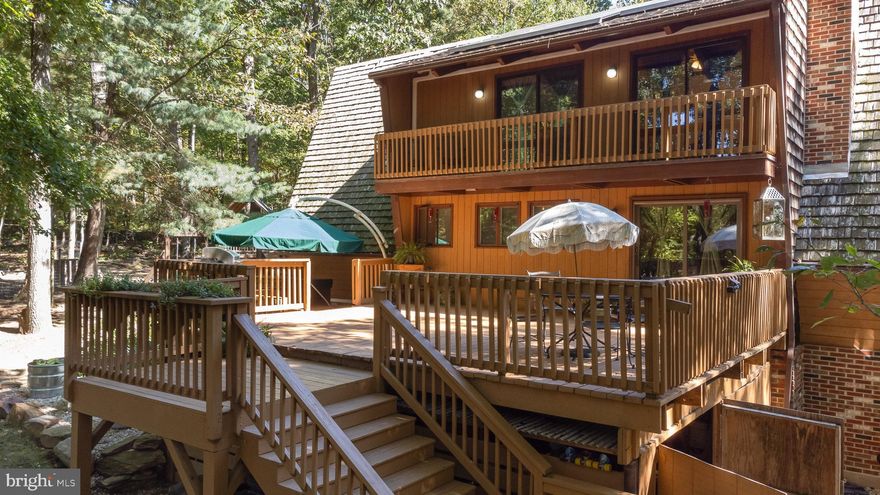 Welcome to this private oasis on 6.5 acres, with 4 bedrooms and 3 full baths in the woodlands of Northern Harford County.  Pull into the long wooded private driveway which ends in a circle with parking pads allowing over 10 parking spaces.  The house is positioned in the middle of the property to ensure maximum privacy and the grounds are gorgeous and have been improved with  walking trails, gardens with planters, Koi fish pond with mature fish and filtration system, a barn and chicken coop with fencing, a bonfire area with custom built adult swingsets, a playground and treehouse with a sandbox, and a 10X20 shed with double barn doors.  
   This Acorn A-Frame is made of Canadian Red Cedar Wood, and is entirely cedar wood inside and out offering a warm, cozy living environment.  The house has 4 decks on every side of the home giving a beautiful panorama of the forest, with one of them holding a hot tub.  Inside on the main level is a massive living area with exceptionally high vaulted ceilings, wood burning fireplace and triangular windows/french doors allowing a full view of the forest.  Off of this area is a dining area that opens into the kitchen with granite countertops, an extra large pantry, deep farm sink, open live edge shelving and live edge breakfast bar.  Down the main hallway is a large laundry room with washer/dryer, a full modern bath and a large primary suite with high ceilings.  Taking the stairs to the top floor brings you to a loft that overlooks the living room with clear views of the treetops and sky and another full modern bathroom, and three bedrooms all with vaulted ceilings, two of which have their own private balconies.  Taking the stairs to the basement brings you to the semi-finished above ground basement which has another full modern bath, a large recreation room with wood burning fireplace, office area and storage.  This basement could potentially be convereted into a walk in (no stairs) in-law suite.  There is a mudroom for jackets and shoes, and also a kids fort under the staircase.
     This home was designed with intention and for energy efficiency, the heating and air both run off of mini splits throughout the home, there is a whole house fan, Anderson windows with roll out functions, all new ceiling fans throughout, and owned solar panels that support the electric usage.  It is supplied with great well water sitting on a geographic high elevation ridge line.  The finishes and layout offer the perfect ambiance with the custom woodworking, the layout, bronze accent fixtures, warm amber lighting, live edges etc.
This home offers the ideal experience for all four seasons, surrounded by nature with vibrant fall colors, snowy winters by the fireplace or the lush greens and flowers that summer has to offer.  This is the. ideal place to raise a family, or enjoy relaxing in your later years.  Come see this gem today!