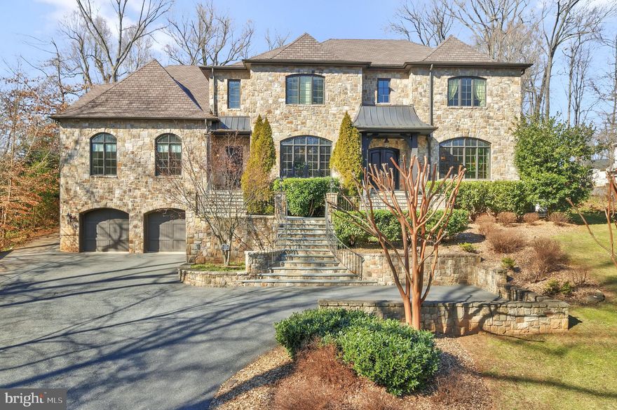 OPEN HOUSE SAT & SUN 2/17, 2/18 from 1-3pm

Meticulously cared-for luxury home built in 2011. Recently refreshed and upgraded and boasting a completely new heated saltwater pool, this gracious home is ready for its next discerning owners. This beautiful, spacious, "inside-the-beltway" Bethesda oasis features a French-style residence with a full stone exterior, over 10,000 finished square feet, 7 bedrooms, 7 full bathrooms, 2 half-bathrooms, a 4 car garage, a balcony, screened porch with retractable screens, relaxing waterfalls and a spacious patio.

Lush landscaping, the coveted pool, and outdoor waterfalls on the .63-acre lot create a private retreat in the area’s most desired location in-bounds for Walt Whitman High School.

Timelessly elegant interior features include reclaimed wood beams adorning the 12-foot ceilings throughout the first level, gorgeous walnut hardwood floors, and a stunning chef’s kitchen with two spacious islands. French doors from the family room and kitchen open to an outdoor space with limitless entertaining potential. Brand-new outdoor features include a fully screened-in porch with retractable screens, a large patio hosting an outdoor kitchen with a new grill and countertops, and a second waterfall feature in the newly constructed pool.

The main level offers a sought-after main-level guest bedroom, an office, a large, dedicated laundry room or mudroom, a full bathroom, and a rear staircase providing access to the primary bedroom suite. The upper level boasts 4 bedroom suites with full, ensuite bathrooms. The third level offers another full bathroom and bonus space ideal for a playroom, workout room, an additional office, or a 7th bedroom. The lower level houses a recreation room with a wet bar, a home theater, a built-in stage, a recreation game area, and 7th full bathroom.