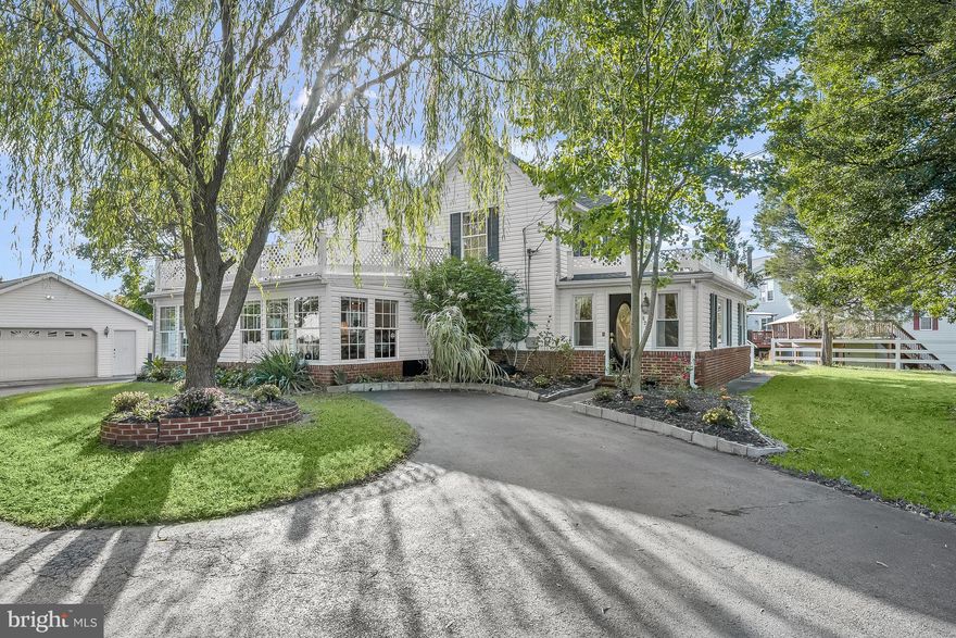 Welcome to this private oasis, where a spectacular 0.54-acre lot is adorned with beautiful landscaping and a private security gate. The property boasts a main level bedroom suite and an additional living space on the top level with two bedrooms and a second kitchen. As you step inside, the front living room offers a great space to unwind, while the formal dining room impresses with hardwood floors, elegant chair railing, and crown molding. The fully equipped eat-in kitchen is complete with stainless steel appliances, granite countertops, a center island with a breakfast bar, a pot filler, and an accent backsplash and ceiling. Adjacent to the kitchen, the cozy family room features plush carpeting, sun-filled windows, and a pellet stove, providing a comfortable retreat. Down the hall, the main level hosts the primary bedroom suite, featuring a walk-in closet, laundry room, and a private bathroom with a walk-in shower, and a soaking tub. Ascending to the second level reveals a versatile space with a separate outside entrance through the sitting room. This level includes a second kitchen with a dining area and additional laundry. Two bedrooms and a shared full bathroom complete this flexible upper level. Downstairs, the unfinished basement offers abundant storage space. Practical features include tons of parking and an oversized two-car detached garage. Outside, the patio and spacious rear yard provide ample space for various activities, making it a perfect outdoor retreat.