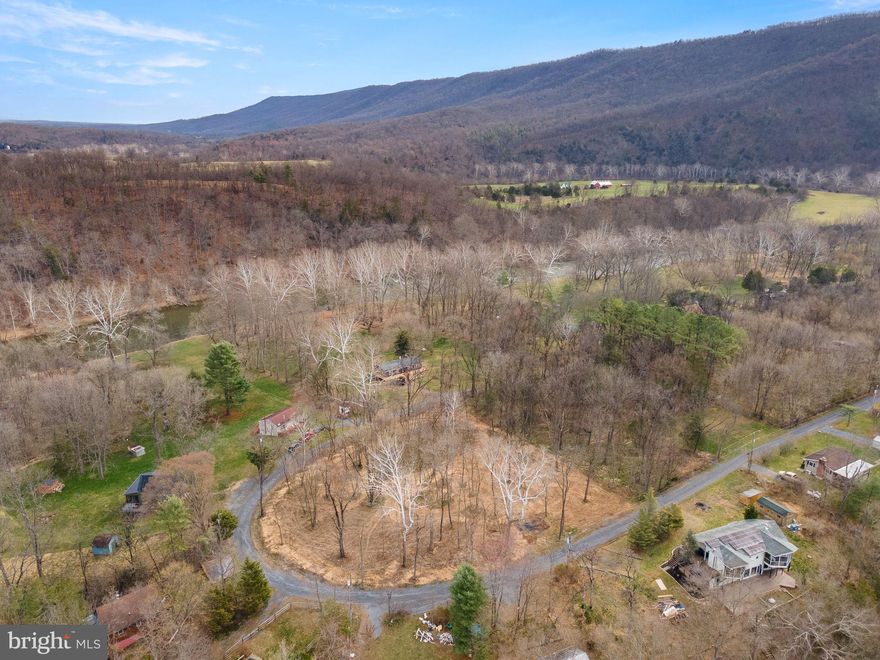 This 1 acre building site with views of the river and mountains! Having a 4  bedroom certification letter  and a newly drilled well, approx. 140 feet deep w/15 gallon/minute flow.     The land has been thoughtfully cleared, leaving a few shade trees but open enough to build a home with views from every window!   Picture your weekends relaxing on covered porches and decking, after floating or fishing the Shenandoah!   Easy, private community access to the Shenandoah River and even National Forest access for hikers and hunters.      This river community has minimum restrictive covenants and road maintenance dues, currently $100/year.   Located less than 10 minutes from Route 11 and another 10 min to I-81 access and under 2 hours into NoVa.