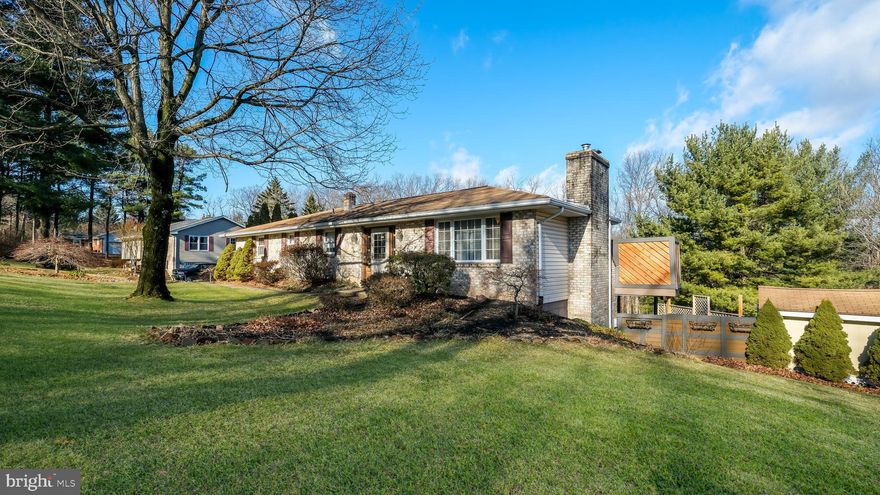 Welcome to 6129 Beverly Hills Rd, Coopersburg, PA, a distinctive 3-bedroom, 2.5-bath brick ranch nestled on a generous .93-acre open lot. Flooded with natural sunlight, the main living areas feature pre-finished hardwood flooring throughout the living and dining rooms, creating a warm and inviting first impression. The well-appointed kitchen offers granite countertops and opens seamlessly into a bright breakfast nook with tranquil views of the expansive rear yard and glass slider access to the rear deck—perfect for everyday living and entertaining alike.
The main level includes two bedrooms, highlighted by a spacious primary suite complete with a large walk-in closet and an oversized private bath featuring a soaking tub, separate stall shower, and double vanity. A convenient hall half-bath is currently set up with a washer and dryer and can easily be converted back to a traditional tub and shower, with laundry relocation options available in the basement.
Indoor-outdoor living shines with three sliding glass doors—2 leading from the first floor to a  rear deck with vinyl deck boards and  newly installed steps down to the rear yard, and another glass slider from the finished basement opening to a paver patio. The outdoor space is ideal for relaxation and gatherings, featuring custom-built bench seating, an included hot tub, and shed.
The finished basement expands the living space with a cozy family room with fireplace, a third bedroom, and a second full bathroom with stall shower. An additional area with laundry hookups and cabinetry offers excellent potential for an in-law-style living setup or flexible use space. NOTE: This home is not currently zoned for in-law quarters; buyers and their agents should independently verify permitted use and any required approvals with the local municipality.
Rounding out this home’s unique offerings is a two-car built-in basement garage with an extra nook—perfect for storage or a home gym as was utilized by current seller—along with a walk-up attic providing even more storage. With its versatile layout, expansive outdoor space, and abundance of features, 6129 Beverly Hills Rd is a truly special home you won’t want to miss.