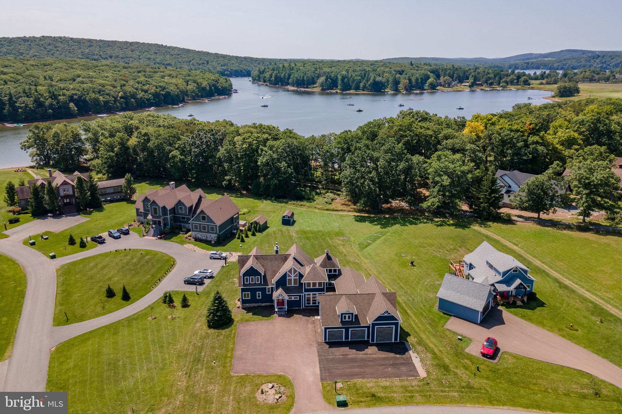 Discover the ultimate lakefront retreat in the prestigious Waterfront Greens community! This expansive 6 bedroom home offers three levels of beautifully designed living space, perfect for entertaining or relaxing with family and friends. Enjoy a private indoor pool, multiple recreation areas, and a massive garage with room for vehicles, storage, and a full gym setup. This home is also an established rental with Railey Vacations, called "Lake Side Lodge." Step outside to a stunning lakefront setting with a dedicated dock slip in the community dock. As part of Waterfront Greens, you'll also enjoy exclusive amenities including a par 3 golf course, tennis courts, walking trails, and a catch-and-release fishing pond. Whether you’re soaking in the peaceful views, enjoying a day on the lake, or hosting unforgettable gatherings, this property offers an unbeatable lifestyle in one of Deep Creek Lake’s most sought-after neighborhoods. A rare opportunity to own a home with it all!
