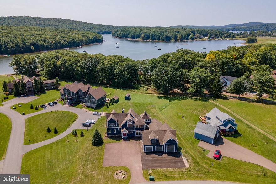 Discover the ultimate lakefront retreat in the prestigious Waterfront Greens community! This expansive 6 bedroom  home offers three levels of beautifully designed living space, perfect for entertaining or relaxing with family and friends. Enjoy a private indoor pool, multiple recreation areas, and a massive garage with room for vehicles, storage, and a full gym setup. This home is also an established rental with Railey Vacations, called "Lake Side Lodge." Step outside to a stunning lakefront setting with a dedicated dock slip in the community dock. As part of Waterfront Greens, you'll also enjoy exclusive amenities including a par 3 golf course, tennis courts, walking trails, and a catch-and-release fishing pond. Whether you’re soaking in the peaceful views, enjoying a day on the lake, or hosting unforgettable gatherings, this property offers an unbeatable lifestyle in one of Deep Creek Lake’s most sought-after neighborhoods. A rare opportunity to own a home with it all!