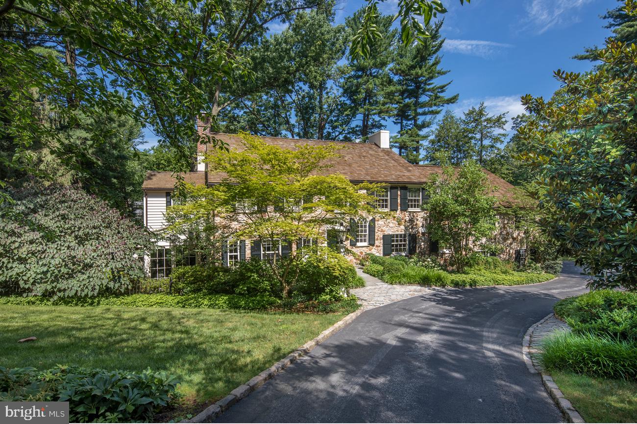 Welcome home to this masterfully crafted Colonial gem in Pembroke Estates, one of the Main Line s truly magical neighborhoods. Curb appeal abounds as you enter the circular drive with a cobblestoned apron from Philadelphia s Liberty Hall, arriving to enjoy a beautiful display of architecture and design. Landscaped grounds, designed by Chuck Hess, provide a new and distinct set of fragrances, bouquets, and visual experiences throughout the seasons. Expertly renovated and expanded by renowned architects Archer Buchanan,the interior was recently transformed to reflect stunning transitional design, while retaining its classic charms. Current owners added their own thoughtful touches and upgrades like fresh paint colors, refinished wood floors, a redesigned chef s kitchen, upgraded powder room, and finished lower level bath. The real wow-factor is the newly-reimagined family room. Nearby the kitchen and breakfast room and introduced by a 30 open arch, it features a wood-burning fireplace (convertible to gas), custom cabinetry & dramatic vaulted v-groove paneled ceiling with painted beams. Windows on 3 exposures including a new large added window & clerestory windows above bathe the space in natural light. Step out French doors to the rear flagstone terrace for outdoor enjoyment. Bright and airy, the home welcomes you with a soaring 2-story foyer and effortless flow from room to room. Chat with guests around the fire in the living room brightened by a wall of windows & glass doors to the terrace. Host parties in the elegant dining room with a custom bow window. A dream kitchen was renovated thanks to the genius of Hankins & Associates, and is highlighted by a large center island, sleek granite countertops, soft-close cabinetry, and premium Sub-Zero & Wolf appliances. A lovely breakfast room, year-round glass-enclosed sunroom, home office with fireplace, mudroom & 2-car attached garage are extra comforts that make this house a special home. Refresh upstairs in your luxurious master wing with walk-in his/her custom closets and calming spa-quality bath. Spacious guest suites are equally well-appointed for a relaxing place to unwind. An area with a custom built-in desk with cabinetry overlooks the family room and functions as a second home office. Your family and friends will love the finished lower level with recreation, game & exercise rooms plus a workshop for the hobbyist. An auxiliary generator & sump pumps provide peace of mind in any weather. In a best of Main Line location; under a mile to Bryn Mawr station (SEPTA express stop) and only minutes to all conveniences & top schools.