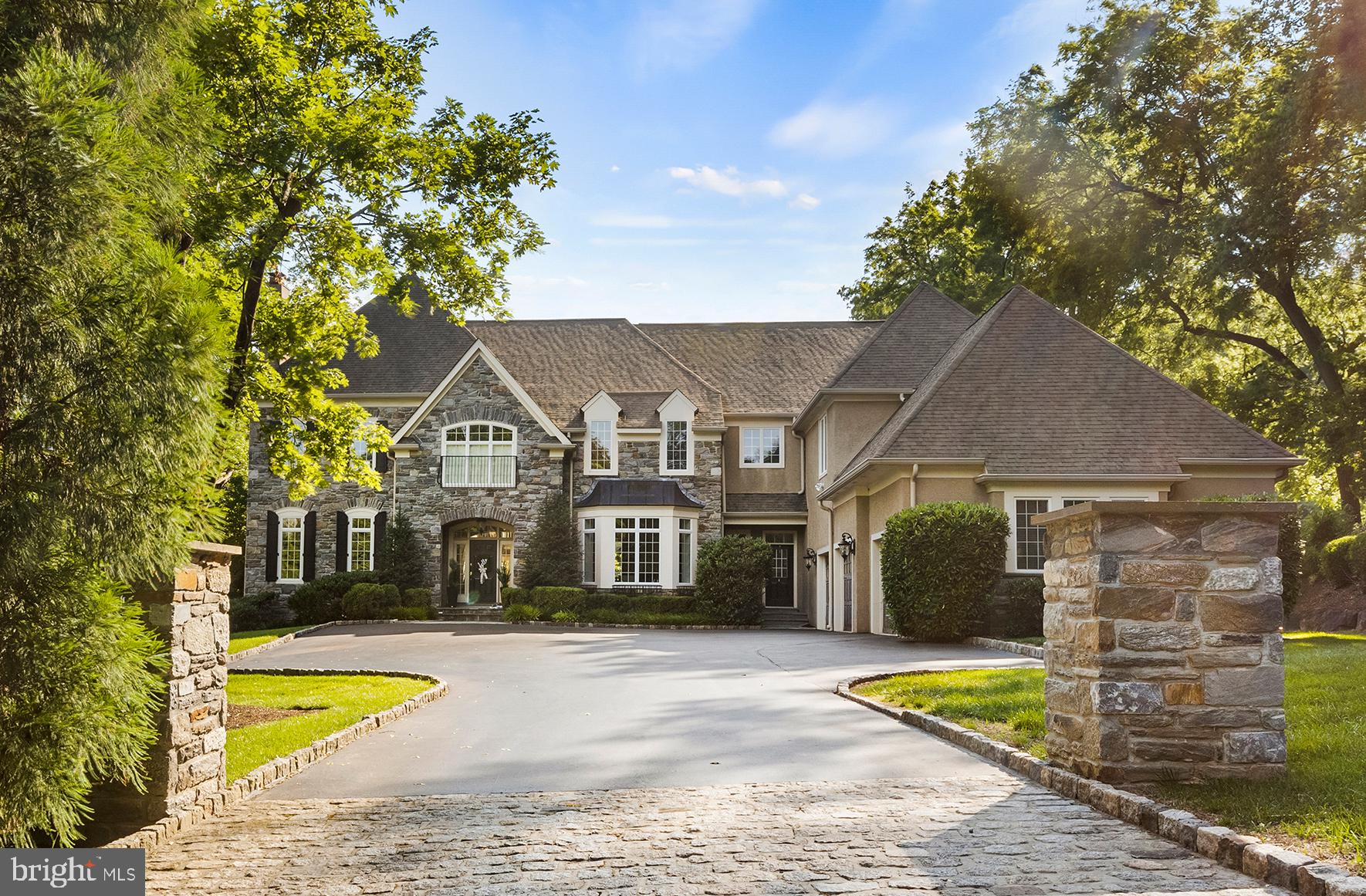 Want for nothing in this Rare to find elegant Executive Dream Home in Wayne, Radnor Township. Stone pillars lead to a large entrance courtyard buffering this lovely Wissahickon Schist Grey Stone home from the street. The large 1+ acre lot has tall trees in the front, an expansive lawn and big view in the rear and is graced by a NEW (2017) 40X17 foot salt water pool, with Pentair system, hot tub and wonderful patio. This peaceful, quiet and private outdoor living space is matched only by the home itself. A tried and true new construction floor plan lives beautifully-comfortably accommodating large gatherings and providing the amenities and flow needed for everyday family life. This elegant home has only had a few owners and each one has upgraded and customized to perfection. This gracious home has an impressive front to back foyer, elegant dining room and inviting living room with gas fireplace, custom millwork and architectural detail. Custom built with 11 foot ceilings and real site finished hardwood flooring, both front and back foyers and stairways, formal powder room as well as mudroom powder room, large kitchen with center island, ample cabinetry, butler station and walk-in pantry. Kitchen is open to the breakfast area and quintessential Great Room with large windows, coffered ceiling, fireplace and custom built-ins. The main bedroom suite is spacious with sitting area, large walk-in closet and huge bathroom with large double vanities. Additional bedrooms have large walk-in closets with custom closet organizers, large upstairs laundry room and children's den area. The walk-out lower level has a family room and ample storage space and there is a 3 car attached garage with wooden carriage doors. Country feel with easy access to rt 476, commute the Phila. International Airport and minutes to the popular town of Wayne with it's many shops and restaurants. Fully stucco tested by State wide Inspections with NO areas of concern. Report available on line.