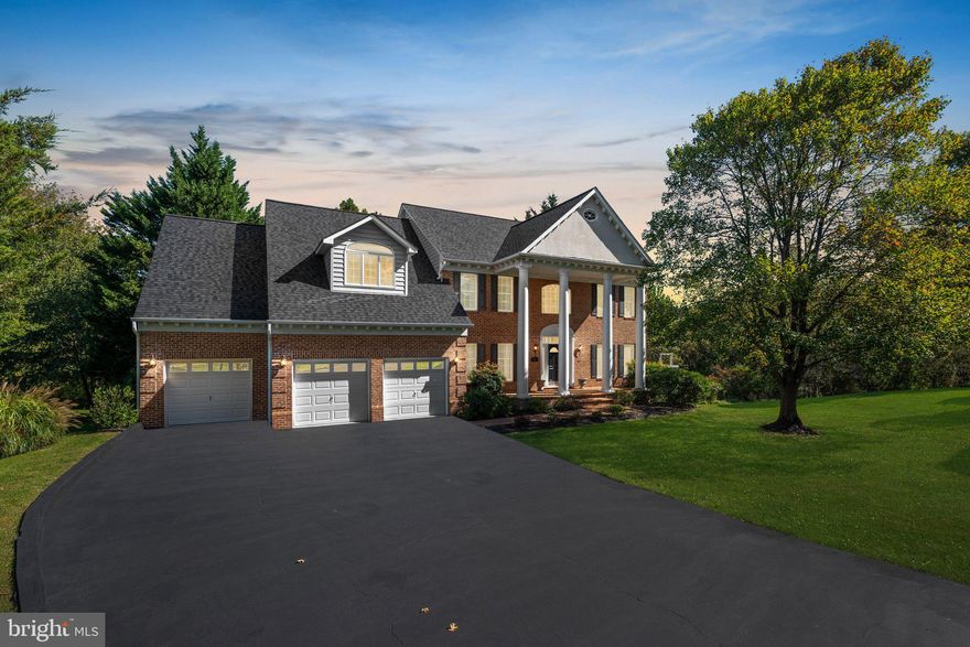 ***STILL SHOWING FOR A BACK-UP*** This stately brick-front home, complete with soaring columns and a brick porch, is located in the highly sought-after Turf Valley Overlook community. Featuring five bedrooms and five full baths, this home sits on one of the most private lots in the community. Backing up to the serene David Force Park, you have hundreds of acres of forestland right behind your home. Upon entry, you’re welcomed by a grand two-story foyer, highlighted by a front door with transom and sidelights. The main level boasts 10-foot ceilings, elegant three-piece crown molding, and hardwood floors throughout. Also, this home features two staircases leading to the upper level, where a catwalk overlooks both the family room and the foyer below. The kitchen is equipped with a 5-burner gas cooktop, stainless steel appliances, granite countertops, and a service bar area that flows into the dining room. An atrium door opens to a sprawling deck, perfect for outdoor gatherings. Both the living room and dining room feature hardwood floors with inlaid borders, as well as crown molding and chair rail accents. The living room includes a charming bay window bump-out. An office or den with built-in shelving and an atrium door to the deck, or flexibility as an additional guest bedroom, conveniently located next to a full bath on this level. The two-story family room features newer hardwood floors, a raised-hearth gas fireplace, palladium windows, and recessed lighting. Upstairs double doors lead to the expansive primary bedroom, complete with a cathedral ceiling, a cozy sitting area, and atrium doors that open to a private balcony overlooking the yard and park. This retreat also includes a wet bar, a gas fireplace, and an adjacent room that could serve as a study or nursery. The primary bath is well-appointed with a double sink, an extended counter, a separate shower, a water closet, and a relaxing whirlpool tub. A cedar closet and a Jack-and-Jill bathroom round out the upper level. The lower level with 9' ceilings offers a generous recreation area with built-ins, a gas fireplace, a bedroom, a full bath, and atrium doors that open to the patio and backyard. Flat backyard with plenty of space for a pool (buyer to verify with county/HOA). The outdoor space is ideal for entertaining, featuring a large deck spanning the width of the back of the home and with built-in seating and a patio area. The home is well-maintained, with a roof and siding that are approximately two years old and oversized downspouts. The property includes a four-car garage with built-in storage, featuring a three-car entrance and extra depth to accommodate a fourth car. Constructed with R54 blown-in insulation and 2x6 framing, this home is both beautiful and built to last. Basement finished square footage is estimated. 1 Year AHS Best Coverage 'Shield Complete" Home Warranty Included.