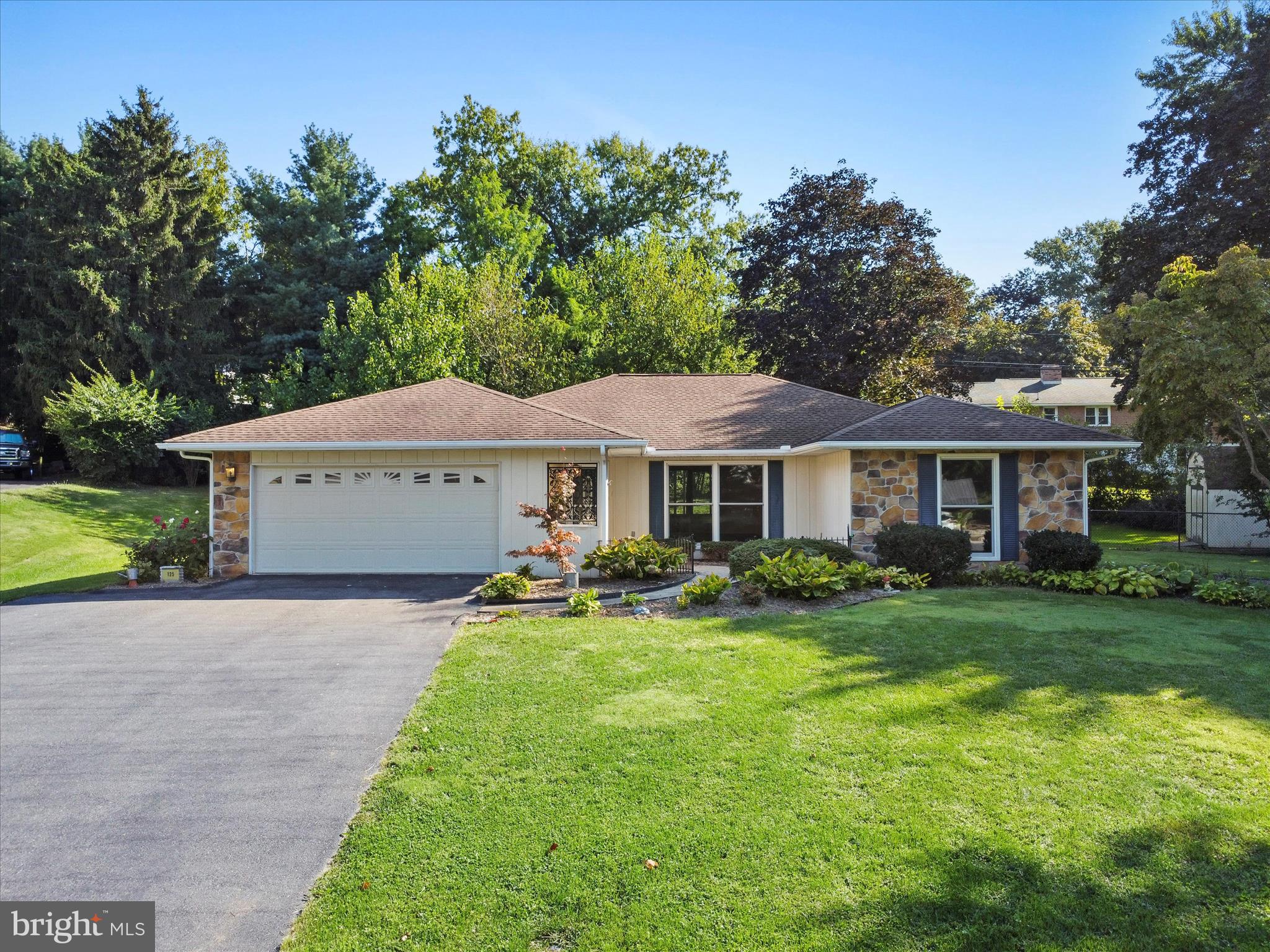*Check out the 3D tour!* Main level living in a well maintained home located in convenient South Guilford Hills. The curb appeal shows for itself with a large covered front porch space and a vertical siding plus stone look on exterior. This 2 bedroom, 2 bathroom home has an open concept living/dining/kitchen space with LVP flooring newly installed plus fresh paint. The kitchen has an island complete with granite countertop. One bathroom near the kitchen can serve as a guest bath for visitors but also has a stand up shower. The bedrooms are on the side of the home with the primary bedroom offering a walk in closet plus connecting doorway to the main hall bathroom with a larger shower and 2 vanities. The hallways also provides two other closets that can be used for linens or other storage. The 2nd bedroom is to the front of the home and has a large window and a nicely sized closet. The back porch was enclosed and heat/air vents ducted to the outside making it fully finished space. The backyard has a nice amount of the yard fenced with a chain link fence and a nice patio plus a shed. The garage has an automatic opener and plenty of extra space, plus a pull down stairs set to over the garage storage. HVAC was replaced by Larry & Sons providing comfortable electric heat and cooling; windows are Andersen. This property is an estate and will be sold as-is, but is in very good condition. Floor plan in photos is for reference but is not guaranteed exact measurements.