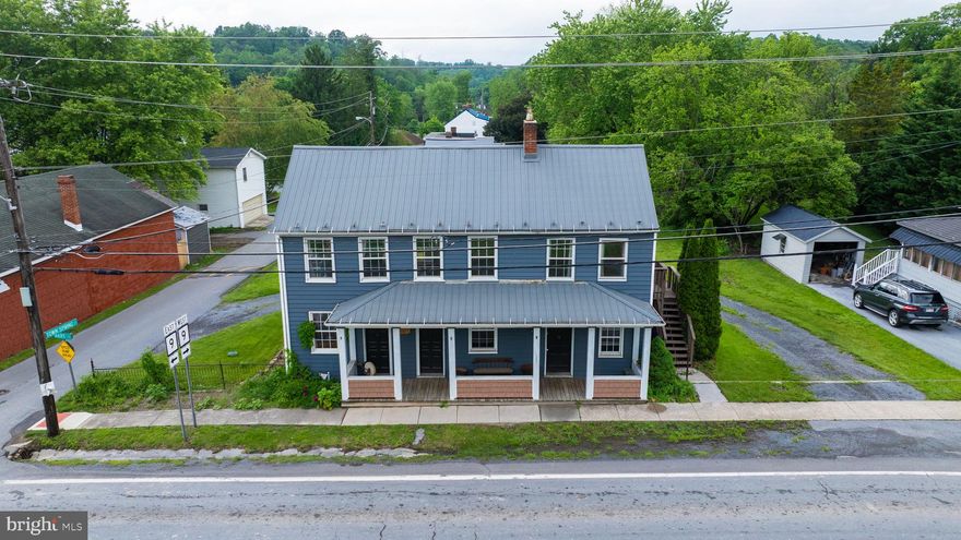 Own a Piece of History in the Heart of Hedgesville! This beautifully revived 1830s Colonial-style home seamlessly blends historic charm with modern updates. Zoned for both commercial and residential use, the property presents a range of opportunities—whether you're envisioning a unique business location, a one-of-a-kind residence, or a profitable investment property. Major improvements have already been completed, including a newer roof, updated water heater, electric, plumbing, siding, windows, and more. Step inside to a thoughtfully preserved interior featuring original hardwood floors paired with new tile. The kitchen offers granite countertops, a spacious walk-in pantry (a rare feature for a home of this era), and newer appliances. The inviting dining room showcases original exposed beams, while the living room boasts custom built-ins and a beautiful original brick fireplace. The first-floor primary suite includes a fully renovated en-suite bath with a luxurious standalone soaking tub. Upstairs, you'll find two generously sized bedrooms and a charming parlor room between them—complete with another original fireplace. Beyond its historic character and thoughtful upgrades, the home includes standout features like a spacious walk-up attic with potential for future expansion, as well as a first-floor laundry and mudroom conveniently located off the kitchen. Outside, enjoy an expansive deck perfect for entertaining, and a large lot—one of the biggest in the Hedgesville Historic District—that provides plenty of space and privacy. A circular driveway with two entrances offers easy access and ample parking. While much of the heavy lifting has already been done, the home still offers room for personalization and modern touches, giving you the flexibility to make it truly your own. A separate exterior entrance to the upper level makes this property ideal for a two-unit configuration or potential Airbnb use—adding to its versatility and long-term value. Home is on Historic registry and being sold AS IS. Schedule your showing today!