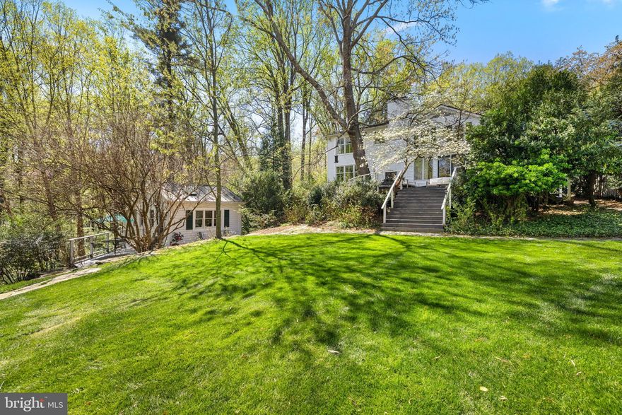 NEW PRICE!  Come experience a timeless 1912 white clapboard home nestled on 1.14 acres in the sought-after Franklin Park area. The home, surrounded by lush landscaping and mature trees, exudes historic charm, elegance, and warmth. In the back yard, on a hill overlooking a stream, is a four-level guest cottage, providing a rare opportunity for extended family accommodations, a private home office, or rental income.

THIS OFFERING INCLUDES BOTH 6137 FRANKLIN PARK RD, A BUILDABLE LOT, AND 6139 FRANKLIN PARK RD, WITH A WONDERFULLY CHARMING HOUSE AND GUEST HOUSE, FOR A TOTAL OF 1.14 ACRES. TOTAL ASSESSED VALUE IS $2,775,930.

As you enter the gracious foyer of the main house, you are immediately transported to a home that feels rich with history and character, filled with modern touches that make it both functional and stylish. The primary living room is anchored by a wood-burning fireplace and accented by large windows that flood the space with natural light while offering stunning views. The formal dining room provides a perfect setting for memorable dinners with family and friends. Adjacent to the dining room is a spacious sunroom with comfortable seating, large windows, skylights, and a glass door opening onto a spectacular deck with breathtaking views of the expansive grounds. This sunroom, with adjacent to a full bathroom, can also be used as a first-floor bedroom. The light-filled kitchen features skylights, a beamed ceiling, ample counter space, a dining area, and a cozy seating area with a wood-burning stove. Just off the kitchen, the mudroom provides excellent additional storage for groceries, appliances, and coats.

Upstairs, the primary en suite bedroom features serene views of the lush grounds below. This spacious room is designed with comfort in mind, creating a peaceful sanctuary where you can relax and recharge. Four additional bedrooms on the upper level provide ample space for family, guests, or a home office, and they share a well-designed hall bathroom with timeless finishes.

The lower level of the home expands the living space significantly, adding a walk-out family room with a wood-burning fireplace and many windows, an exercise/game room, a guest bedroom, and a full bathroom.

The four-level guest house features its own kitchen, breakfast area, living room, bedroom, and full bathroom. With views of the lower yard and stream, it offers both privacy and tranquil comfort for guests or residents alike.

This sought-after location combines the peace of a secluded retreat with easy access to urban amenities—only a short drive to both Washington, D. C. and Tysons Corner. The Chesterbrook Shopping Center is just a short stroll away, offering Starbucks, Safeway, Sorn Thai, South Block, and more. The additional buildable lot offers options as a separate investment or future additional home. Whether you’re looking for a home to raise a family, host unforgettable gatherings, or simply enjoy the serenity of nature from your own backyard, this one-of-a-kind residence provides the perfect setting.