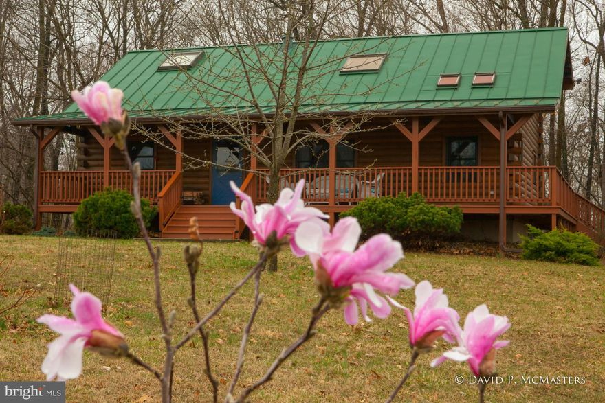 Lovely, secluded cedar log home in big lot subdivision with Potomac River access. Home is on cul-de-sac and has seasonal river view. VERY cozy and attractive with great added sunroom where you will likely want to live full time. Vaulted ceiling, hand built stone hearth for wood stove.  Big master bedroom, tile bath, 3 garage spaces, 2 in det  shop/gar. Beautiful gourmet kitchen. EZ commuter access