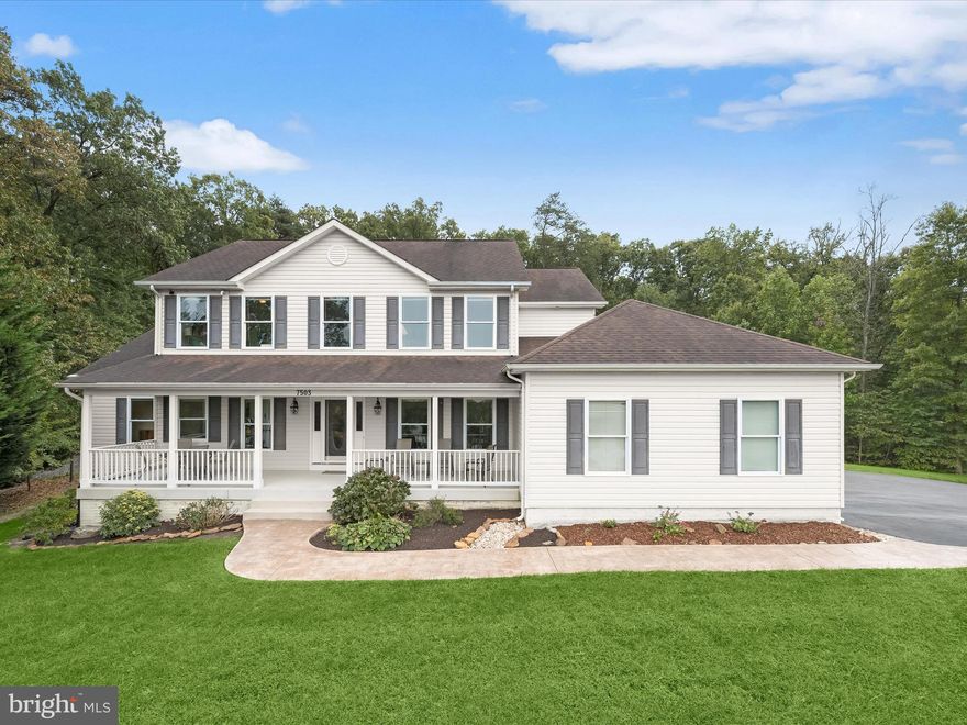 Introducing this four bedroom, three-and-a-half-bathroom residence with three finished levels of living space, blending privacy, elegance, and modern comfort. Set on 1.73 acres at the end of a quiet cul-de-sac, the home is surrounded by lush woods with walking trails, creating a peaceful retreat. A covered front porch offers the perfect spot to enjoy a morning coffee before stepping inside to a foyer with elegant moldings, a neutral color palette, and rich hardwood floors that continue throughout the main level. Entertain guests in the formal dining room or relax in the living room beneath a soaring two-story vaulted ceiling. French doors lead to the sunroom with beautiful views of the surrounding woods and greenery. The kitchen showcases granite countertops, a tile backsplash, center island, walk-in pantry, and 42” cabinets, with a breakfast nook just steps away for casual dining. A spacious mudroom connects to the oversized two-car garage with abundant storage and a 240-volt EV outlet. The main level primary bedroom suite provides a quiet retreat with sound-dampened exterior walls, double windows, and an ensuite bathroom featuring a heated floor with a timer, a soaking tub, dual vanity, and a walk-in shower with dual heads. Direct access to the laundry room adds everyday convenience. A half bathroom completes the main level. Upstairs, three spacious bedrooms include one with a large walk-in closet, accompanied by two full bathrooms with tub-showers. A loft-style sitting area overlooking the living room creates an ideal spot for a reading nook or home office. Finished in 2023, the expansive lower level features an open concept layout with walk-out stairs to the backyard and rough-in plumbing for a future full bathroom, offering endless options for customization to suit your needs. Outdoor living is equally impressive with a stamped concrete patio and fire pit surrounded by nature. Recent updates include new carpet (2024), kitchen counters and backsplash (2024), and an insulated garage door with a quiet opener. Additional highlights include an 80-gallon high-efficiency water heater, dual-zoned HVAC systems, hardwired security camera system, storm/security doors, and more. There's many more special features in this incredible custom home, please see the MLS Documents for a full list.