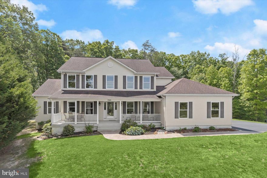 Tucked at the end of a quiet cul-de-sac and set on 1.73 wooded acres, this four-bedroom, three-and-a-half-bath home offers a rare balance of privacy, space, and everyday convenience. With over 4,000 square feet above grade, the layout is designed to give you room to spread out, gather, and live comfortably.

A covered front porch welcomes you into a light-filled foyer, where hardwood floors, classic moldings, and a neutral palette create an inviting first impression. The main level offers a variety of living spaces that feel both connected and purposeful. A dramatic two-story living room with a vaulted ceiling creates a beautiful focal point, while an adjacent bonus living area provides valuable flexibility for a playroom, home office, or additional lounge space depending on your needs. A formal dining room is ideal for hosting and gathering.

The kitchen sits at the heart of the home, featuring granite countertops, a center island, walk-in pantry, and 42-inch cabinetry, along with a bright breakfast area. It’s designed to flow easily into the surrounding spaces, making both everyday living and entertaining feel natural and comfortable.

The main-level primary suite is set apart for privacy and offers a true retreat at the end of the day. With sound-dampened exterior walls, double windows, and a spacious en-suite bath featuring heated floors, a soaking tub, dual vanity, and a walk-in shower with dual heads, it’s a space that feels both relaxing and practical. Direct access to the laundry room adds an extra layer of convenience. A powder room completes the main level.

Upstairs, three generously sized bedrooms, two full bathrooms, and a loft-style sitting area create a separate living zone that works beautifully for family, guests, or work-from-home needs, allowing everyone to have their own space while still feeling connected.

The lower level, completed in 2023, adds over 2,000 square feet of open, flexible space with walk-out access and rough-in plumbing for a future full bath. Whether you envision a recreation area, home gym, media space, or additional living quarters, it’s ready to adapt to your lifestyle.

Outside, a stamped concrete patio and fire pit are surrounded by mature trees, creating a peaceful, private setting. The rarely available expansive treed lot offers the opportunity to either expand and customize your backyard living space or simply preserve the privacy and natural setting that makes this home feel like a retreat.

Recent updates include new carpet (2024), kitchen countertops and backsplash (2024), and an insulated garage door with a quiet opener. Additional features include an oversized two-car garage with a 240-volt EV outlet, an 80-gallon high-efficiency water heater, dual-zoned HVAC, and a hardwired security camera system. A full list of updates and features is available in the disclosures.

Ideally located approximately 10–15 minutes from Fort Meade and the National Security Agency, with easy access to I-95 and Route 32 for commuting to Baltimore, Washington, and surrounding areas.

Homes that offer this kind of space, flexibility, and privacy at this price point are becoming increasingly hard to find, especially when compared to nearby Howard County communities like Columbia and Ellicott City.
Some images have been virtually staged.