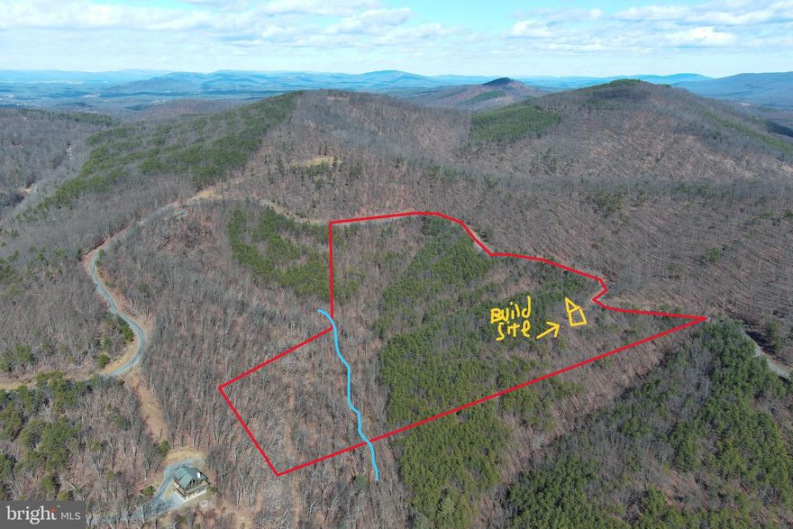 A LITTLE OF THIS + A LITTLE OF THAT = A REALLY NEAT PROPERTY....21 PRIVATE WOODED ACRES THAT HAS A LITTLE BIT OF EVERYTHING ON YOUR WISH LIST; MOUNTAIN VIEWS, SEASONAL STREAM, TRAILS & DIVERSE FOREST WITH GOOD TOPO. FOR STARTERS YOU HAVE A NICE AND EASY LEVEL BUILD SITE WITH ADEQUATE MTN VIEWS JUST OFF THE ROAD, SUPER LOW INFRASTRUCTURE COSTS TO DEVELOP YOUR BUILD OR CAMP SITE. POWER & PERKED.... 150-200 FT DRIVEWAY & ELECTRIC PULL IS ALL THAT'S REQUIRED TO GET TO THE SPOT.....HIDDEN TRAIL LEADS TO A LARGER TRAIL IN HARDWOOD HOLLOW WITH MULTIPLE SPRING HEADS THAT FORM THE LARGER STREAM. 3 DRAWS CONVERGE IN THE MAIN HOLLOW CREATING THE ULTIMATE WILDLIFE CROSSING....THIS LOT IS LOADED WITH GAME!  LOCATED IN THE PRESTIGIOUS GATED COMMUNITY OF "THE BLUFFS ON THE POTOMAC".....THE BLUFFS IS KNOWN FOR IT'S ABUNDANCE OF BIG BUCKS, BEAR & TURKEY. AS AN ADDED BONUS, THE COMMUNITY HAS IT'S OWN PRIVATE COMMON AREA ON THE SOUTH BRANCH OF THE POTOMAC RIVER FOR CANOE, KAYAK, TUBES, FISH & SWIM......A PRIVATE PARK ON THE RIVER FOR YOUR SUMMERTIME ENJOYMENT. EASY TO GET TO BUT HARD TO FIND, LOCATED NEAR THE END OF A LIGHTLY USED ROAD.....VERY PRIVATE, YET ONLY 1.5 MILES OFF THE COUNTY ROAD AND 2 MILES FROM THE RIVER ACCESS. HAVE A LITTLE BIT OF EVERYTHING WITHOUT BREAKING THE BANK...HUNT, SHOOT, CAMP, ATV'S OR BUILD....EVERY OPTION IS ON THE TABLE AT A VERY REASONABLE PRICE....IF YOU AINT FIRST, YOU'RE GONNA BE LAST ON THIS ONE!