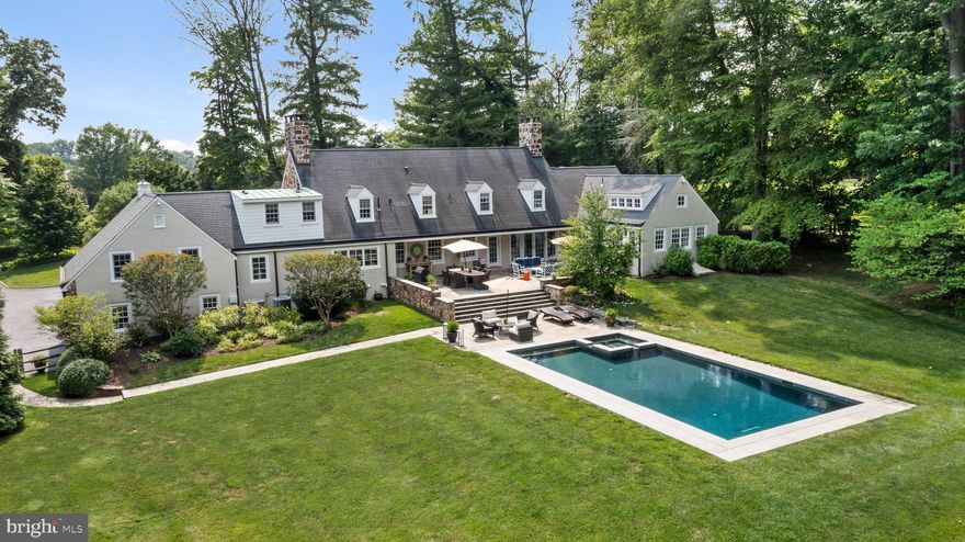 Serene elegance abounds from the moment you arrive at 276 Abrahams Lane, as this historic  gem immediately captures your heart and exudes quality and sophisticated living.  Originally part of the Ardrossan estate, this magnificent 2 acre property quietly blends into its surroundings and has long been admired by many. Nestled amongst mature landscaping, this home embodies refined living and designed for those who appreciate a lifestyle of understated elegance and comfort. Years of meticulous redesign and updates have elevated this estate to a rare level of luxury and sophistication. Gleaming hardwood floors seamlessly connect  the eloquent  First Floor where formal and informal spaces harmoniously blend together, creating an open floor plan to be enjoyed daily and entertained in often. Understated elegance abounds and this custom home was  masterfully created to capture the backyards majestic setting that will take your breath away. The stunning  craftmanship can be felt room to room with an abundance of luxurious features that set it into a class of its own. Both the gracious Living and Dining Rooms feature deep windowsills and fireplaces, artfully blending  into the  gourmet Kitchen, Breakfast  and Sitting Areas. A true chefs delight the Kitchen is highlighted by a massive teak island, brick Aga stove with custom metal hood, Miele refrigerator armoire and so much more.  A lovely custom banquette provides a cozy seating area with stunning display cabinetry  flowing  into the adjoining Sitting Area with  entertainment center. The warmth of the home continues up to into the vaulted Family Room with lacquered paneled  walls providing the perfect venue for movie/tv viewing. On the opposite side of the home the most heavenly First Floor Primary Suite awaits offering a private sanctuary of comfort and luxury.  It features vaulted ceilings with rustic beams that enhance the spaciousness of the room, while walls of windows flood the space with natural light and offer  tranquil views of the lush  backyard oasis.  French doors lead directly from the suite to the Patio, perfect for easy access to your private outdoor retreat. A spa like Primary  Bath with deep soaking tub, double vanities and walk-in shower gracefully connects into the most fabulous custom his and her Dressing Rooms, designed with exceptional built-ins, ensuring all clothing and accessories are neatly organized and accessible. The First Floor is completed by a lovely Powder Room and a gracious staircase leads to the Second Floor where three en-suite Bedrooms can be found. Each suite features exceptional Bathrooms and outfitted closets with a  Second Floor landing providing  the perfect area to relax and  read a book. The Lower Level offers an additional 1,235sq ft  of finished family friendly space with  a sliding barn door that opens to a brand new Full Bath. The Lower Level is completed by a Laundry Room, Storage Room, and  Mudroom conveniently located off of the 2 car attached Garage. The magic continues outside where flagstone tired terraces gracefully lead to the newly built salt water pool creating an exquisite centerpiece that seamlessly blends into a carpet of grass. For all sports enthusiasts, a small portion of the backyard has turf out of respect respect not to disturb the backyard oasis.  Don't miss your opportunity to own 276 Abrahams Lane, which not just a residence but a prized jewel  in the heart of Radnor Townships  Ardrossans  neighborhood.