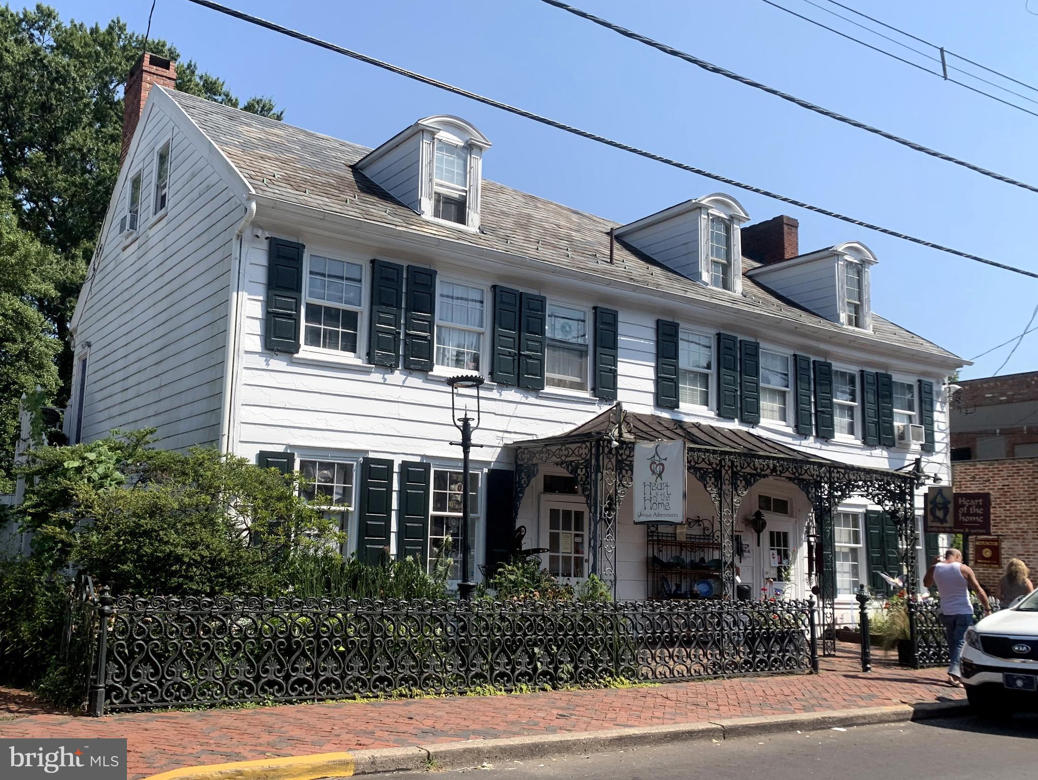 Available for the first time in two decades: one of the most prime commercial locations in all of downtown New Hope offers historic charm, multiple income-producing units, and one of the largest pieces of riverfront green space anywhere in town. Dating back to the late 1700's and widely considered the oldest wood-frame home in New Hope, the main building is prominently situated in the fine dining/shopping district (flanked by the Ferry Market, Logan Inn, Marsha Brown's and Mansion Inn, just to name a few) and currently offers over 2,500 sq ft of showroom space indoors and out plus top floor offices. A partitioned second floor apartment within the main building could offer additional income, a work-where-you-live option, or expand the commercial space to incorporate the entire building. The layout of the main level could also lend itself to dividing into two shops, or wherever your creative vision takes you! Down either of the two (2!) herringbone brick driveways and you'll enter a "secret garden" world of the sprawling back yard, lined by rented cottages, which leads to the 80+ feet of continuous river frontage mostly consisting of stone patio seating areas. In the cooling shade of a 200+ year old willow tree (recognized by the National Arborist Association as significant) the three residential rentals and one commercial tenant enjoy an exclusive enclave that never suffers long from vacancies. Walk down the stone steps to the river's edge and boat dock, and soak in the views of the sunrises/sunsets. Opportunity knocks to bring your business vision to this truly one-of-a-kind property.