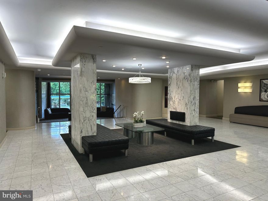 You will love living at Sutton Terrace! It is luxurious living with amenities,  friendliness and the feeling of being on vacation year round. There is a 24/7 door person building with excellent support staff to help you with packages, groceries and other needs. The people who live here love the way of life. This 1322 (office verified) square foot 1 bedroom + den is mostly used as a 2 bedroom condo has 1 ½ baths and was reconfigured to enhance the openness of the condo. The entry way was changed so that as you step into the property, there is a wide open space in front of you allowing you to see the entire wall of windows and views beyond. The gleaming dark wood floors are the perfect backdrop for elegant rugs. The property was just painted in designer colors and the bedroom/den are newly carpeted with lovely soft neutral colors. The handsome black granite countertops and white kitchen cabinets in the kitchen floor plan were redesigned to maximize the efficient use of the space. The slight curve and the way it is contiguous to the kitchen gives the dining area character.  It has windows for air flow on nice weather. The wall scones and dining room fixture provide subtle, soft lighting. There is a gracious flow of the dining room into the living room. The long end of the living room can be used as another sitting area or a dining area. The view from this 9th floor allows you to see over the treetops and the city in the distance. Take the hallway to the left, the den /2nd bedroom is on your immediate right with a full closet. The hall continues to a linen closet on the right and a big walk in closet on the left. The wash/dryer is on your left. As you walk ahead, the angled door to the bathroom leads to the enlarged bathroom. The long vanity and counter have plenty of storage. Look at that beautiful glass wall in the enlarged shower! This shower is easy to use and has so much space. The primary bedroom is roomy and has another wall of windows. The library and fitness center are on the first floor. The newly redecorated social room is used for meeting, speakers, playing cards, games and entertainment. The grounds have lush plantings and are well kept. A beautiful new fence was installed around the perimeter of the lot. The location of the building has easy access to the city, suburbs and airport. Shopping is right across the street. It is a beautiful neighborhood to live in with charming homes nestled close to mature trees and plantings. The pool is open to everyone for a $145 per member. The indoor garage spaces when available are $140/month. There is a $2500 refundable move in fee after living at Sutton Terrace for 30 months. The condo fee is $1203/month which includes $879 monthly association fee + capital reserve fee of $143 + masonry loan of $146 until 2/28, and $35 for electric.