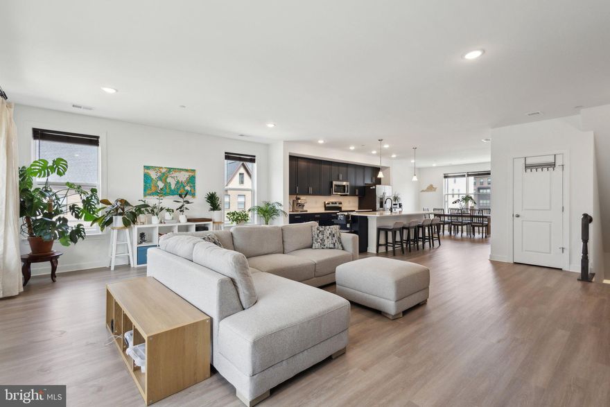 Built in 2024, offering 2,474 sqft of thoughtfully designed living space—this is the widest condo you’ll find in Northern Virginia and the largest unit being sold in the community! With no neighbors above you, this home provides exceptional privacy, modern design, and unbeatable convenience.

Step inside to an open-concept layout bathed in natural light, featuring luxury vinyl plank (LVP) flooring throughout—no carpet! The spacious family room flows seamlessly into the dining area and a gourmet kitchen equipped with stainless steel appliances, granite countertops, a stylish backsplash, and an oversized island—perfect for entertaining. Step outside onto the expansive deck, ideal for gatherings and outdoor relaxation.

Upstairs, the luxurious primary suite offers dual walk-in closets and an upgraded spa-like ensuite bathroom, complete with an oversized frameless glass shower and extra built-in cabinets for added storage. The convenient upstairs laundry makes everyday living effortless and enjoyable.

Enjoy low-maintenance living in a vibrant community with plenty of green space, pocket parks, a bocce court, and a playground. Community members also have access to a free EV charging station, and the EV charger in the garage ensures you'll always have a full charge at home.

Located just minutes from Wegmans, Lazy Dog, and Crumbl Cookie. For the avid travelers, Dulles Airport is only 15 minutes away, and with easy access to I-66 and Route 28, this home is perfect for commuters and those seeking a blend of comfort and accessibility.