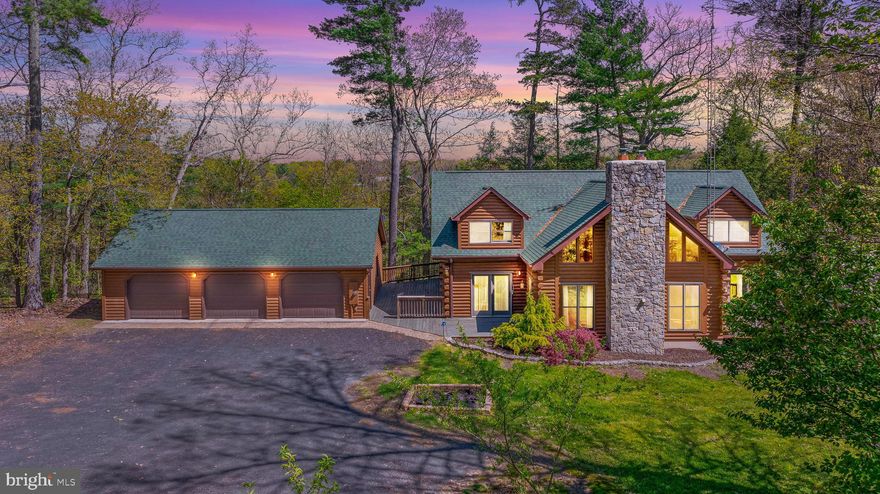 A true Dream Home for the person who craves the quiet serenity of being surrounded by nature yet also wants the perks of modern upgrades. Nestled away on just over 4 wooded acres with a lovely creek winding through, you're sure to love everything this home has to offer. This contemporary log style home welcomes you inside with extensive wide plank hardwood floors and exposed ceiling beams that give a warm and cozy feel, but also offers plenty of living space to spread out. The large family room is sure to be the main gathering place with its 2-story vaulted ceiling, stone mantle fire place, and gorgeous windows that let the sunlight flow in. The half-bath is just off of the family room. Just a few steps away is the kitchen that will make anyone's inner chef beyond impressed! Boasting a gas range with commercial hood, built in steamer, teppanyaki grill, built in convection and conventional dual ovens, dish washer, dish drawer (ideal for washing smaller loads), and MANY more bells and whistles! This is the spot that will be the heart of your home and the envy of your friends and family. The attached dining area makes entertaining a breeze. At the other end of this floor is the Master Bedroom Suite...and the word impressive doesn't even touch it. The bedroom itself has french doors that step out onto your private deck where you can sit with a good book or relax and take in the beauty of your private paradise. The Master Bathroom boasts an antique style bathtub that will help soak away the worries of your day. There is also a large stall shower, plenty of vanity space, attached walk-in closet with custom shelving, and laundry room. Upstairs you'll find two additional bedrooms with vaulted ceilings, full bathroom, and loft style sitting room that overlooks the family room below. There is also easy access to the attic area that makes storage a breeze. The basement is not finished, but offers additional storage or can easily be turned into future living space. Here you'll find a cast iron wood burning stove, active radon system, water treatment system, and UV system for the well water. Outside is just as impressive as inside with a large wrap-around deck and a breezeway that attaches to the oversized 3-car garage. The garage also has a small hen house built in with easy access for you from inside the garage and access to the outdoors for chickens. There are so many more amenities and upgrades! Homes like this truly only come along once in a lifetime. Schedule your tour today!