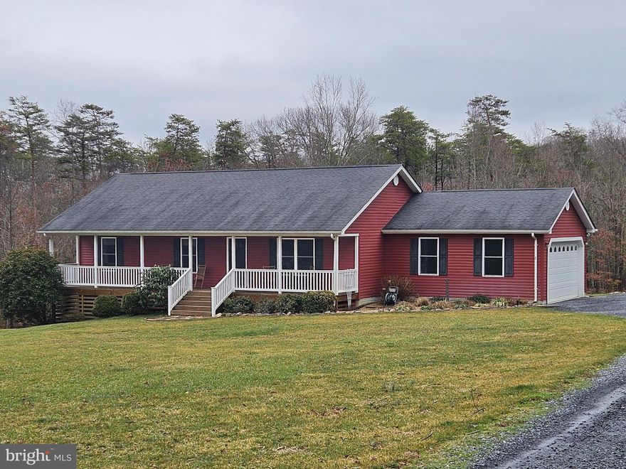A magnificent home on 5.57 acres, with direct walk-in access to the George Washington National Forest. In a private setting at the end of a cul-de-sac, this home boasts multiple outdoor features to take in its wonderful surroundings, with a full width front porch, a large fully covered 24 x 12 south facing main back deck, an additional 14 x 10 lower back deck, and a patio area out in the back yard, with stone fire pit. Inside, you’ll find an impressive spacious great room with vaulted ceiling, recessed lighting, and beautiful hickory wood floors. There is also a full height stone fireplace and hearth, with gas log fire and a wooden mantle hewn from a hickory tree felled when the lot was cleared for building. The kitchen boasts a full suite of stainless steel appliances, and extensive hickory cabinetry. The main floor is completed by the primary bedroom with its own bathroom, plus two further bedrooms and the hallway bathroom. If all that is not enough for you, then check out the lower level, with a superb family room and walkout to a small patio area at the side of the home, bonus space behind the family room, a fourth bedroom, full bath, and an extra room suitable for a  den, man cave, or study!  The unfinished utility room contains washer & dryer, laundry sink, water softener, chest freezer, and plenty of storage space with some shelving remaining.  This home has been extremely well maintained by the owner, and only feels like a 4 or 5 year old home.  But the true beauty of this property is the expansive yard. Approx 1/3 of the lot is cleared around the house, and the rest of the property consists of gorgeous undulating mixed deciduous & evergreen woodland, including two seasonal creeks that cross the property, and leading back directly into the National Forest with the Buzzard Rock Trail passing by. The agricultural zoning and modest covenant restrictions allow for shooting, ATV’s etc, and of course the National Forest is a haven for hunters as well as outward bound enthusiasts. The side-entry garage and wide parking area provide a lot of space for vehicles if needed. There is also a good ride-in shed for mower and garden storage. The heat pump was replaced in December 2023 and comes with a 10 year parts & labor warranty. Chest freezer, metal shelving, fire pit, and the griddle and grille on the deck, all convey with the property. Also available (price negotiable) are a Husqvarna 2017 garden tractor, a Husqvarna push mower, and a Stihl 16” gas chain saw. Seller will need an approx 2 month rent-back agreement with the sale.