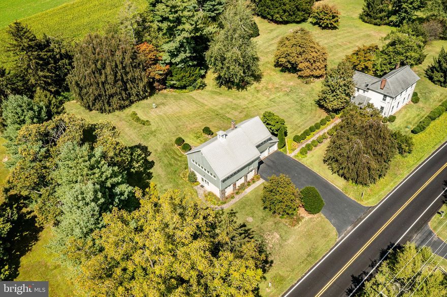 Welcome to Chester County Living at Its Finest! Nestled in the heart of Horse Country, this stunning property is located in scenic Newlin Township, within the award-winning Unionville-Chadds Ford School District. With nearly half of the township protected from development, you’ll enjoy sweeping views of preserved horse farms, the 1,263-acre Ches-Len Preserve, and nearby attractions like Longwood Gardens, Kennett Square’s shops and restaurants, and vibrant downtown West Chester. Conveniently located, this home offers an easy commute to West Chester, Downingtown, Wilmington, and Philadelphia. Set on 3.38 serene acres, this charming 1700s Stone Home combines historic character with thoughtful updates. A flagstone walkway leads through lovely gardens to the welcoming front porch. Inside, greeted by hardwood floors in the sitting room with an adjacent powder room. The living and dining rooms feature 9-foot ceilings, crown molding, restored woodwork, built-ins, a propane fireplace, and curved walls with updated vinyl windows that flood the space with natural light. The functional kitchen, with Corian counters and a stylish backsplash, overlooks the picturesque backyard. A bright sunroom with three walls of windows and tile floors provides main-level laundry and access to the rear yard through the replaced slider (2020). Upstairs, the primary bedroom is large with a full bathroom boasting a skylight and updated shower with Corian surround. Two additional bedrooms, a full bath, and a versatile 10x8 space, ideal for a home office or dream walk-in closet- complete the second level. The basement is dry and functional, the cleanest circa 1700s basement you’ll see! The property also includes a versatile “barn” offering endless possibilities! Highlights include: 3-car garage with epoxy flooring, Former veterinary clinic space with two separate entrances, 18x29 rec room, studio guest suite with kitchenette and full bath, Second-floor breezeway designed to accommodate a vehicle, providing amazing cross-ventilation. With flexible rural zoning, this structure could serve as a guest house, in-law suite, pool house, home business, or simply an open workshop or studio. Lovingly maintained and modernized since 1989, previously by a DuPont executive in the 1950s, the home features modern plumbing (PEX & PVC), upgraded electric, a 2023 high-efficiency propane heating system, and countless thoughtful improvements—offering peace of mind for the next owner. This one-of-a-kind property blends historic charm, modern upgrades, and exceptional versatility—all just minutes from shopping, dining, and major commuter routes. Don’t miss this rare opportunity to own a Chester County estate with both character and convenience!