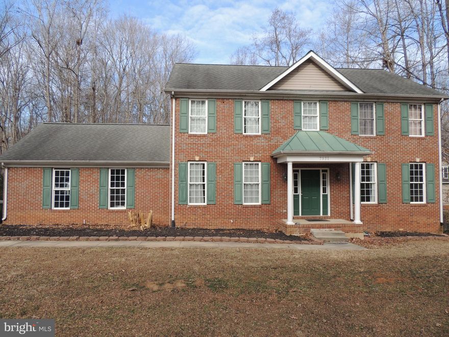 This brick-front Colonial in Spotsylvania has hardwood floors on the main level and new carpet upstairs. The kitchen features granite counters, stainless steel appliances, and ceramic tile flooring. The open layout includes family, living, and dining rooms. Upstairs, the primary suite offers dual closets and a vaulted ceiling; its ensuite bath has a double vanity, soaking tub, and separate shower. Three additional bedrooms, a hall bath, and laundry complete the upper floor. The finished basement adds a large rec room, full bath, and storage.  The rear deck overlooks a spacious backyard on a wooded one-acre lot. Prime location only 15 min to Lake Anna boating/fishing, Spotsylvania Mall/Central Park, and I-95.