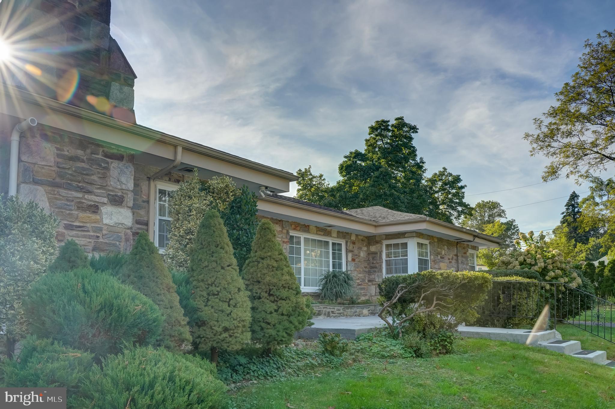 Come to see this exquisite  Stone Ranch home in the exclusive, small community of Greenhill Farms, Just off City Line Ave. The home across from Morris Park on a picturesque lot. As you pull into the tree lined expansive driveway and through the iron gate, you will see this stunning home. This home was built with amazing quality and has a wonderful open floor plan. It is the perfect place to have parties and family gatherings inside or outdoors. As you walk in the front door you will notice the beautiful hardwood floors through out the first floor, the open Great room with a stone fireplace, the Dining room with tons of build ins and completely updated Kitchen with loads of counters and Cabinets.  As you continue you down the hall you will find three large Bedrooms and two baths, one which was renovated with a shower,  jacuzzi tub and vanity. When you walk to the lower level, you will find a huge room with bar and private entrance, and three  additional  rooms. This area has countless opportunities. Outside has a large patio off the kitchen that overlooks the backyard with stone fireplace, perfect for cooking the summer meals.  This home is a must see and will not last. Schedule your private showing now!