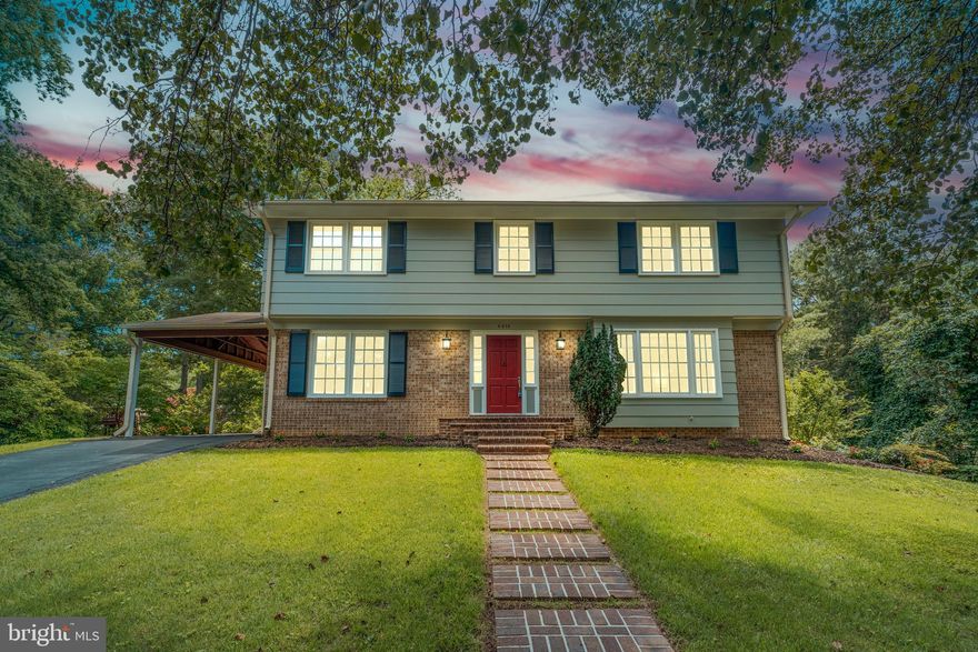 Tucked away in the sought-after Mt Vernon Manor neighborhood, 8618 Gateshead Road offers timeless Colonial charm on nearly half an acre backing to 14 acres of protected parkland. This spacious 4-bedroom, 2.5-bath home features hardwood floors throughout, a renovated white kitchen with a breakfast area, and a sunlit family room. Relax on the freshly refinished deck or gather around the fire pit - plenty of outdoor space to enjoy. On the interior, the expansive primary suite includes a sitting room, three closets, and a private bath. An attached carport, a greenhouse, and beautifully landscaped grounds with mature trees and privacy make this home especially desirable. Additional highlights: freshly painted, blackout shades in the primary, and upgraded USB-compatible outlets in the primary suite and kitchen. The pristine unfinished basement is already plumbed for a bath - amazing potential to finish this valuable square footage exactly the way you'd like. And the wonderful stand-up freezer? Yes, it conveys! Conveniently located, this home provides easy access to major military installations: Andrews, Fort Belvoir, Quantico, or  The Pentagon  - all within easy commuting distance. Don't miss this wonderful opportunity to make this home your own. Schedule your tour today.