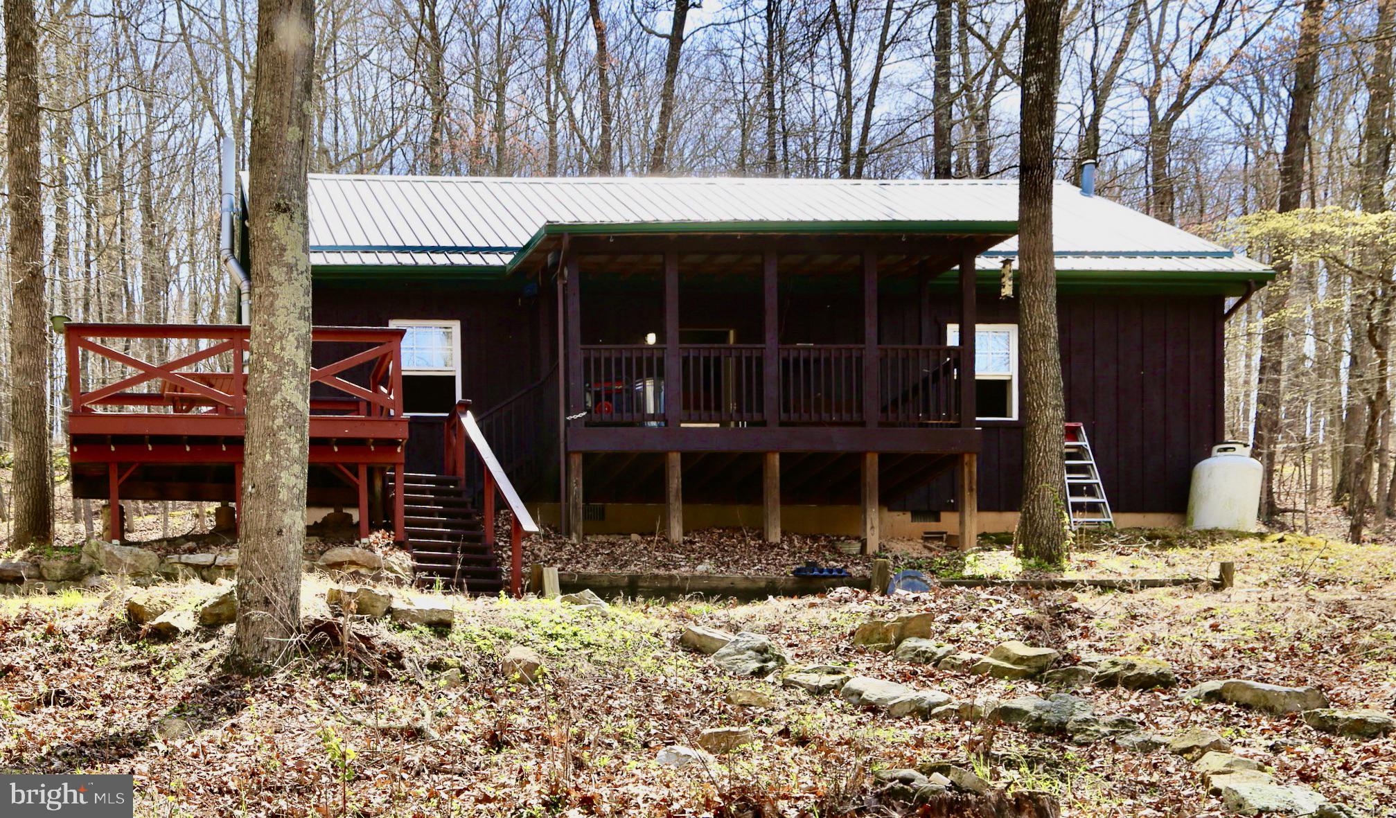Escape to the Mountains – Are you ready to discover the perfect mountain retreat? Nestled on 20.02 wooded acres, this bright and airy cabin offers the peace and privacy you’ve been dreaming of. Inside, you’ll find beautiful wood floors, fresh drywall, and room to personalize. The spacious layout includes 2 bedrooms, 2 full bathrooms, and a large eat-in kitchen perfect for gatherings. Step outside and breathe in the serenity of your very own large pond, surrounded by nature. The property includes multiple storage sheds and a charming detached sauna house – a true escape from the daily grind. Located just 20 minutes from the vibrant town of Moorefield, you'll enjoy easy access to shopping, dining, parks, a community pool, and more. Whether you're seeking a weekend getaway or a full-time residence in the heart of West Virginia, this property is a must-see. Call today to schedule your private showing!