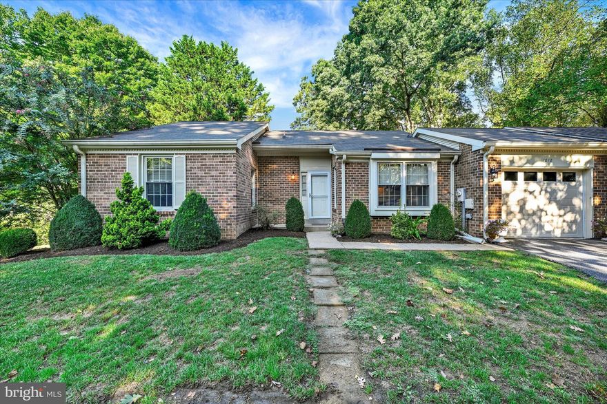 Welcome to this beautifully maintained duplex home in the highly sought-after 55+ Heritage Harbour
community, where elegance, comfort, and resort-style living come together. From the moment you
arrive, you are greeted by a charming front porch and beautifully landscaped surroundings that set the
tone for this pristine residence. Step inside to a welcoming open foyer that leads into a spacious living
room, accented by a classic gas fireplace  that creates a warm and inviting
centerpiece. Tucked just off the living room is a cozy library, offering the perfect spot for a home office or just reading,
relaxing, or quiet conversation. A separate dining room provides an elegant space for hosting gatherings,
while the updated kitchen offers expanded counter and cabinet space, thoughtfully designed to blend
functionality with style. A fabulous three-season room extends the living space, inviting you to
relax and enjoy the serene setting in comfort throughout much of the year. While officially listed as a
two-bedroom, three-bath home, this property offers a rare and valuable feature: a fully finished
basement. This expansive level includes a large family room, full bathroom, a walk-in cedar closet, and a workshop, providing
versatility for visiting family, a live-in caretaker, or quiet hobbies. Storage abounds in both the one-car garage and the lower level. Recent updates enhance both beauty
and peace of mind, including new luxury vinyl plank flooring on the main level and lower level, an updated roof with
gutter guards,  and a freshly power-washed and stained deck. These thoughtful
improvements complement the home’s timeless design and add to its pristine presentation. Life in
Heritage Harbour is centered around resort-style amenities and an active, engaged community.
Residents enjoy exclusive access to the Lodge, featuring an atrium, indoor and outdoor pools, fitness
center, library, boutique, woodworking shop, game rooms, coffee corner, and meeting spaces. Outdoor
amenities abound with tennis and pickleball courts, bocce ball, horseshoes, scenic walking trails, a nine hole golf course with pro shop, and a clubhouse restaurant at Wilder Fresh Kitchen. Water enthusiasts
will appreciate the pier with boat slips, kayak launch and storage, and the RV/boat storage lot within the
community. Combining modern updates, versatile living spaces, and a wealth of community amenities,
this exceptional home offers a lifestyle that is both elegant and effortless. Schedule your private showing today and experience the very best of active adult living in Heritage Harbour. Conveniently located near major routes—including 97, 32, 50, 295, 100, I-95, and 495—it’s an excellent choice for families and professionals commuting to downtown Annapolis, Fort Meade, NSA, CIA, DISA, US Cyber Command, BWI Airport, Washington, D.C., and Northern Virginia.