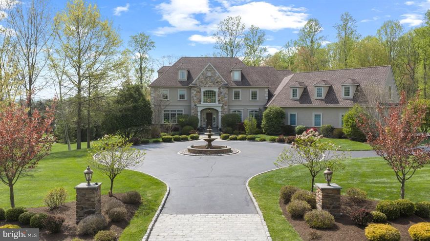 Experience exceptional luxury on 4+ acres in one of Solebury Township’s most coveted enclaves. Ideally positioned on a cul-de-sac, this custom-built Bucks County estate offers a rare combination of acreage, privacy, and architectural presence—introduced by a stately circular drive and fountain that set the tone for what lies beyond.

Step into the marble foyer with a gorgeous curved staircase and premium trim work.  Designed with both everyday living and elevated entertaining in mind, the chef’s kitchen features radiant heated floors, professional-grade stainless appliances, expansive granite surfaces, and an oversized center island with secondary dishwasher and refrigerated drawers. The dramatic 20+ foot coffered family room is anchored by a stone wood-burning fireplace and framed by walls of windows overlooking a serene lawn and beautiful treed meadow beyond. Formal living room with gas fireplace, formal dining room, a butler’s pantry complete with wet bar, and a private office featuring custom built-ins and access to a wraparound covered porch complete the main level.

Upstairs, the primary suite offers a true sense of retreat, with a spacious sitting area, dual walk-in closets, tray ceilings, and a separate flex space ideal for a custom walk-in closet, gym, or perhaps a large second floor laundry room. The spa-inspired bath features a steam shower, jetted soaking tub, dual vanities, and radiant heated floors. Three additional ensuite bedrooms and a full third-floor princess suite provide comfort and privacy for family and guests.

The finished lower level is thoughtfully designed for entertainment, featuring a pub-style bar, gaming area, a dedicated home theater with projection and surround sound, along with another bonus room, a full bath, and a large workshop. And its wall of windows and connection to the backyard do not disappoint.

Outdoors, the expansive grounds offer endless potential, with ample space for a future pool and outdoor kitchen, complemented by patios and a wraparound covered porch. Additional amenities include a generator, an alarm system, and a heated 4+ car garage with premium SwissTrax flooring, many cabinets and shelves, and stairs leading directly to the basement.

Located within the award-winning New Hope–Solebury School District and just minutes from the vibrant rivertowns of New Hope and Lambertville—with convenient access to New York, New Jersey, and Philadelphia—this property represents a rare opportunity to own a private estate of this scale and caliber in the heart of Bucks County.